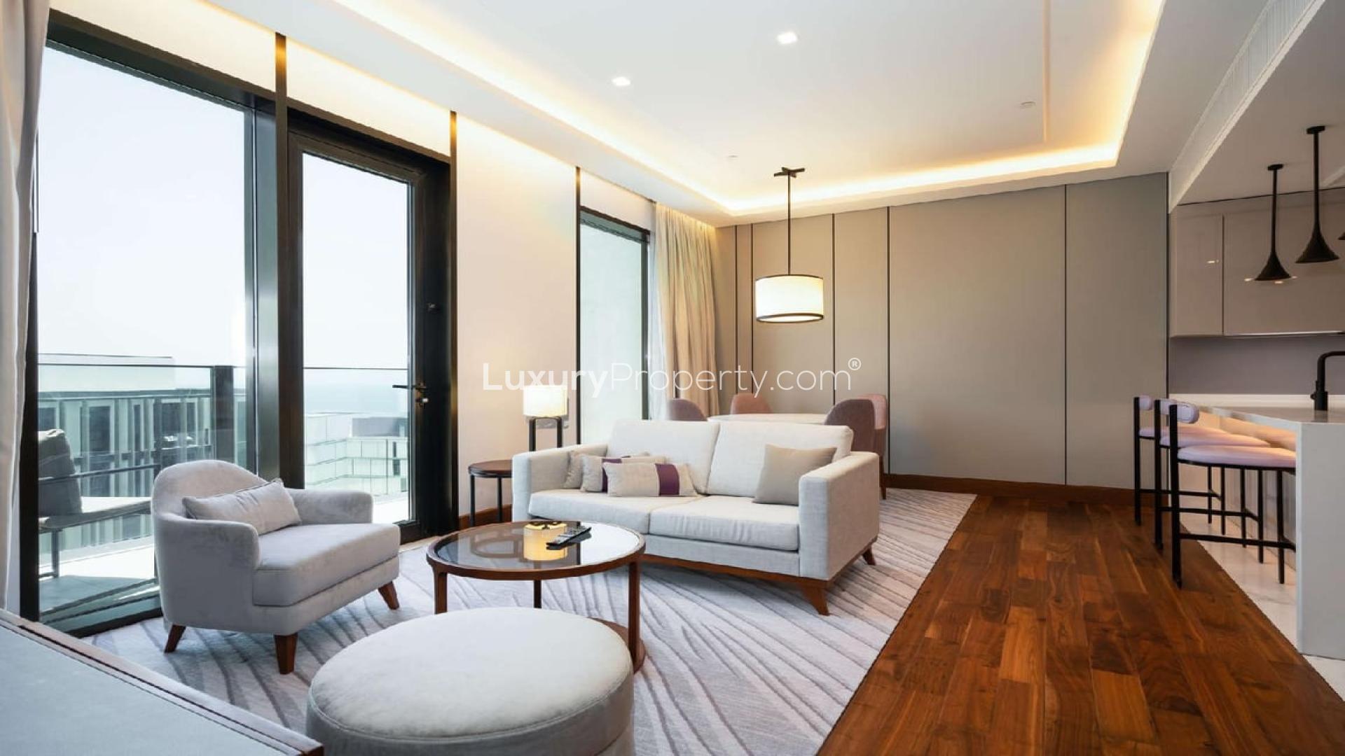 Furnished living room in Caesars Bluewaters Dubai apartment with modern decor and large windows