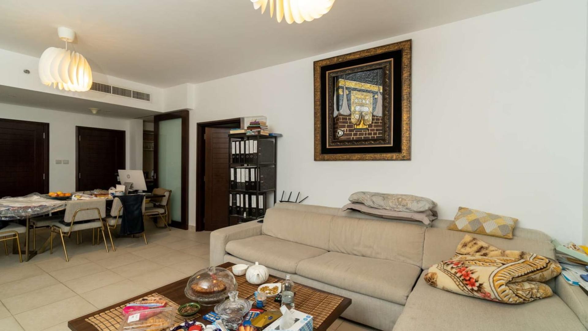 Alt text: "Pool view from balcony at Boulevard Central Towers apartment, Downtown Dubai for rent.",Living room interior of spacious Downtown Dubai apartment, featuring modern decor and cozy seating