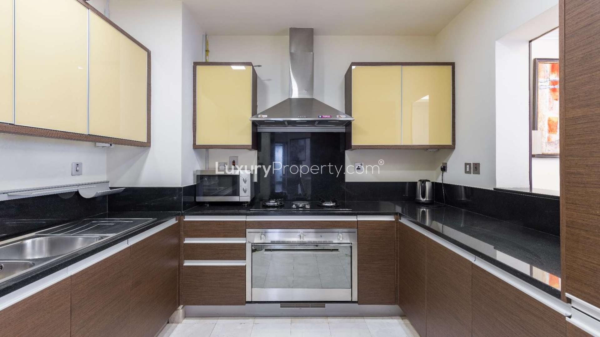 Modern living room in Grandeur Residences apartment, Palm Jumeirah, with elegant decor and balcony view