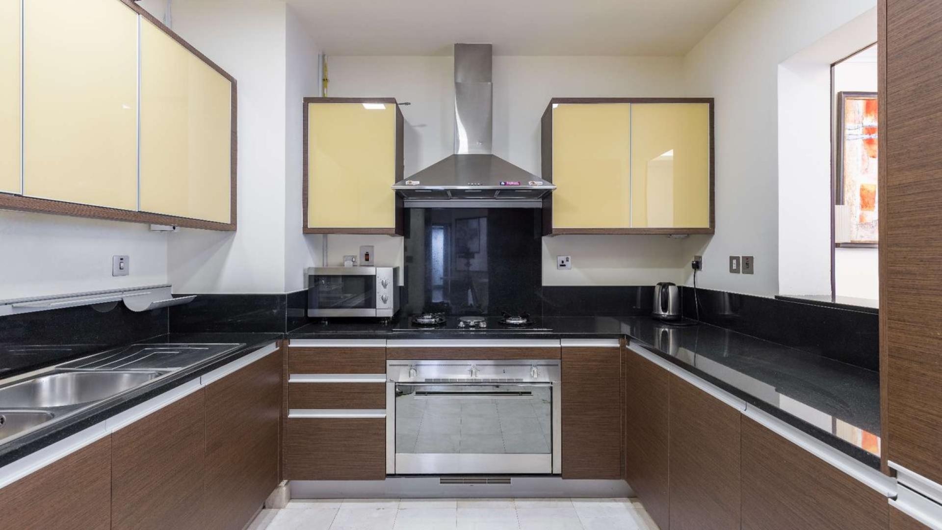 Modern living room in Grandeur Residences apartment, Palm Jumeirah, with elegant decor and balcony view