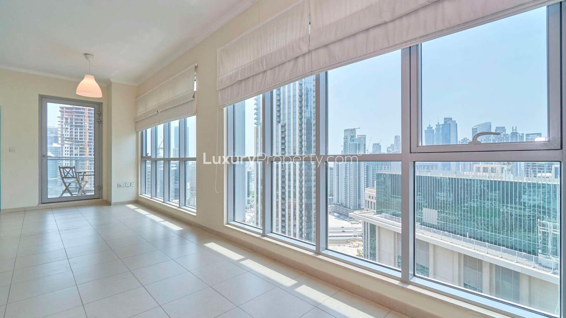 Bright living room in Downtown Dubai apartment with large windows and city views