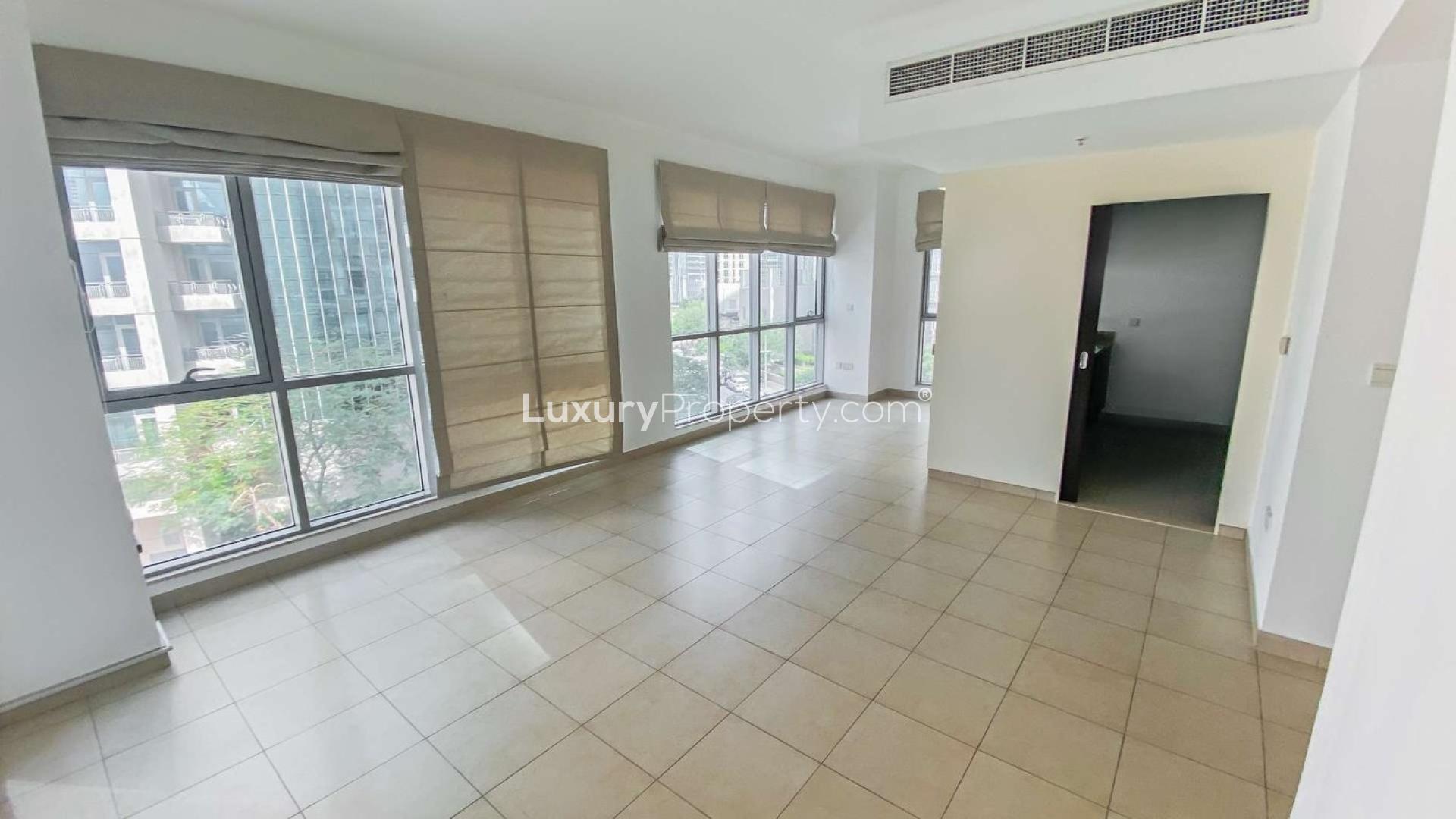 Modern kitchen in 1-bedroom Downtown Dubai apartment, featuring dark cabinets and granite countertops