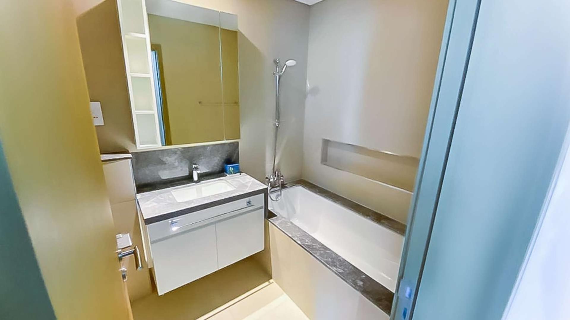 Fully furnished bedroom in Downtown Dubai apartment with stylish decor and cozy bedding