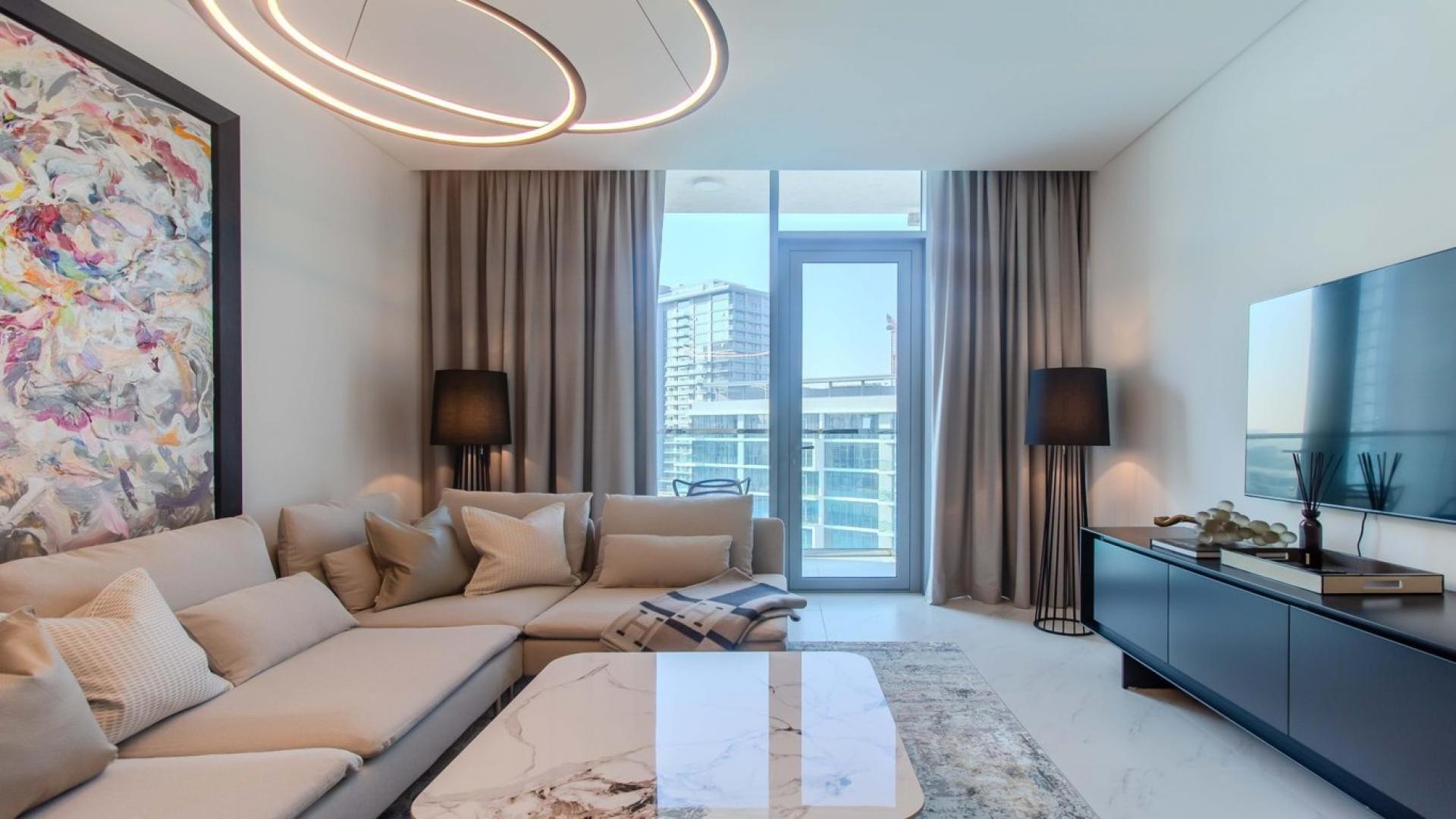 Furnished living room in District One apartment, modern decor, abstract art, open-plan layout