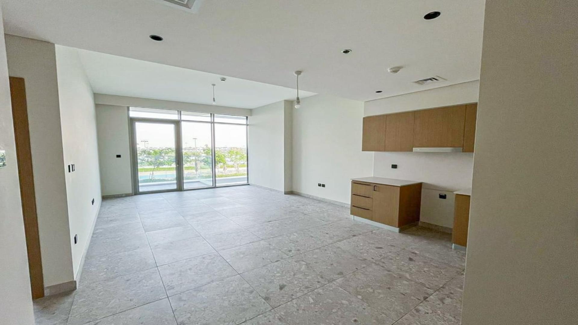 Apartment balcony view of golf course and pool at Dubai Hills Estate