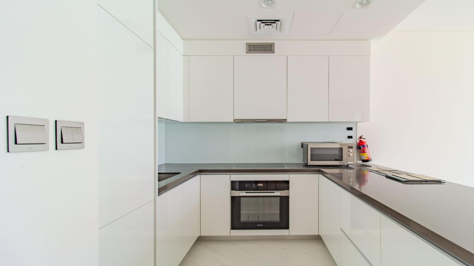 Modern kitchen and living area in District One apartment, Mohammed Bin Rashid City