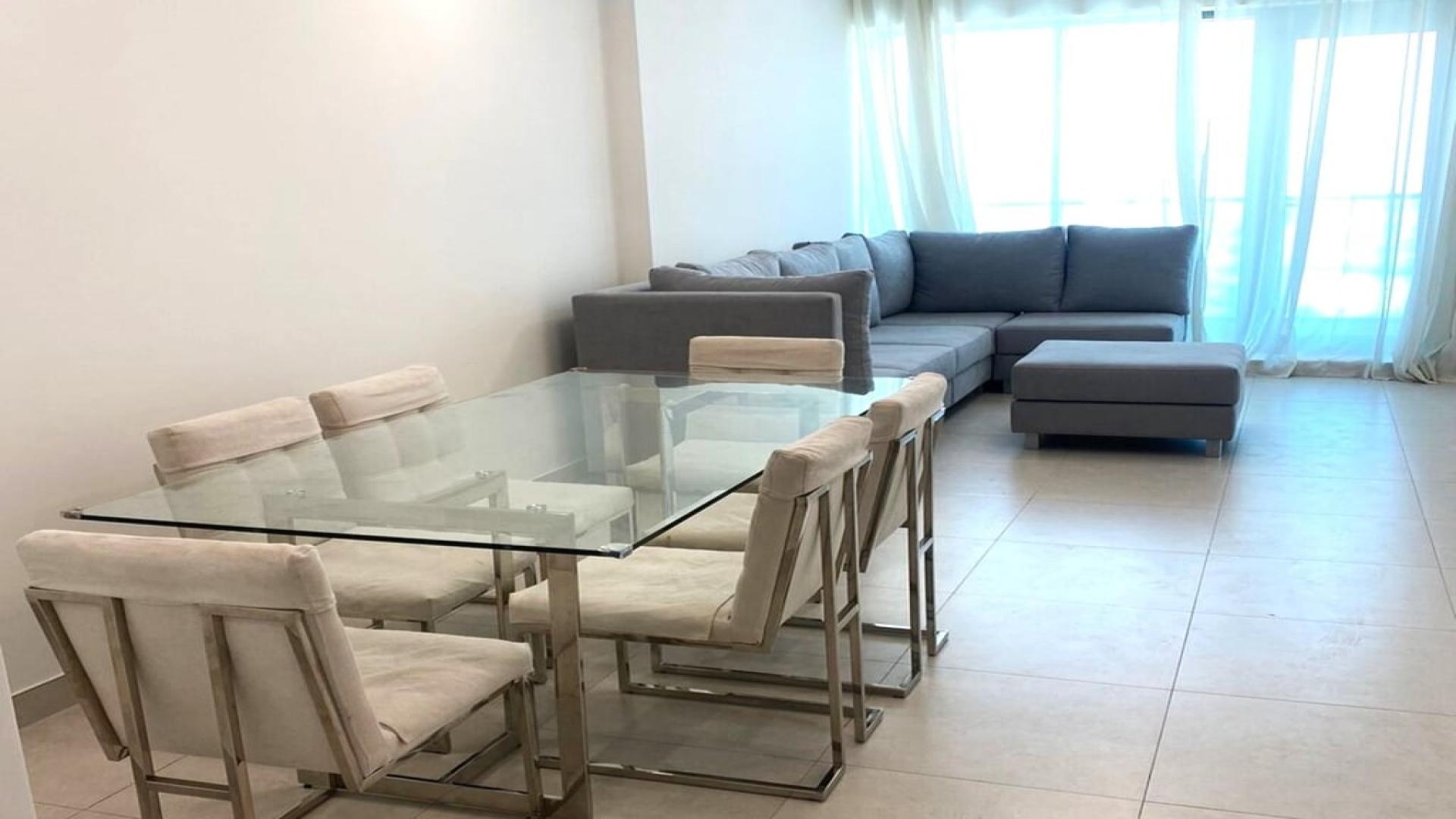 Furnished apartment in Business Bay with cozy grey sectional sofa and natural light