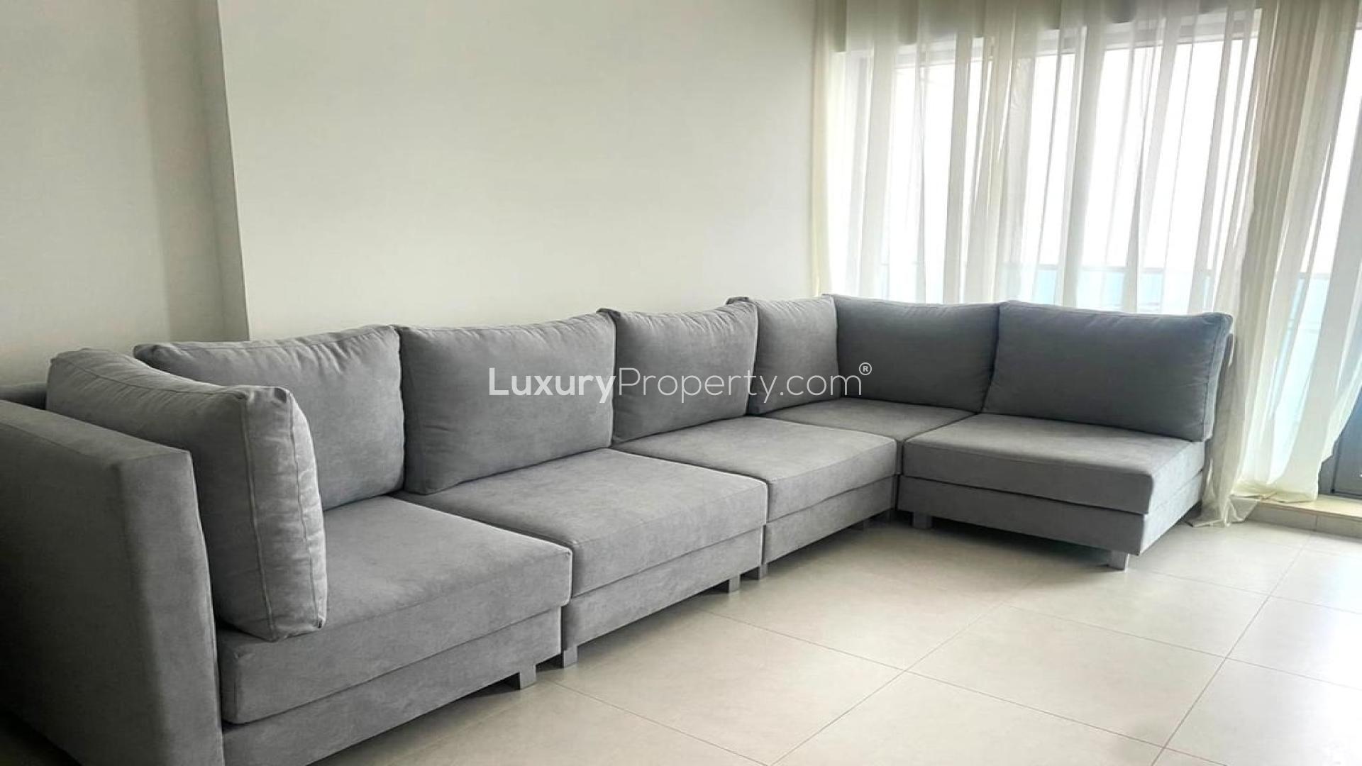 Furnished high-floor apartment living room with glass dining table in Business Bay rental unit