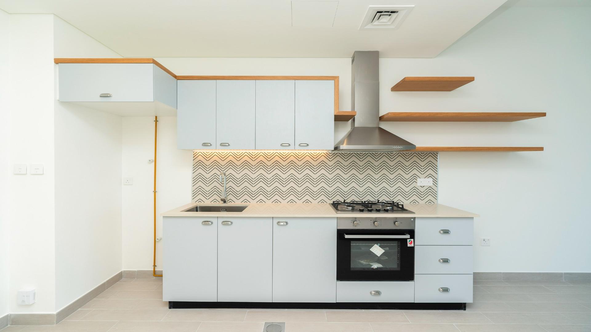 Brand new apartment kitchen in Golfville, Dubai Hills Estate with balcony view