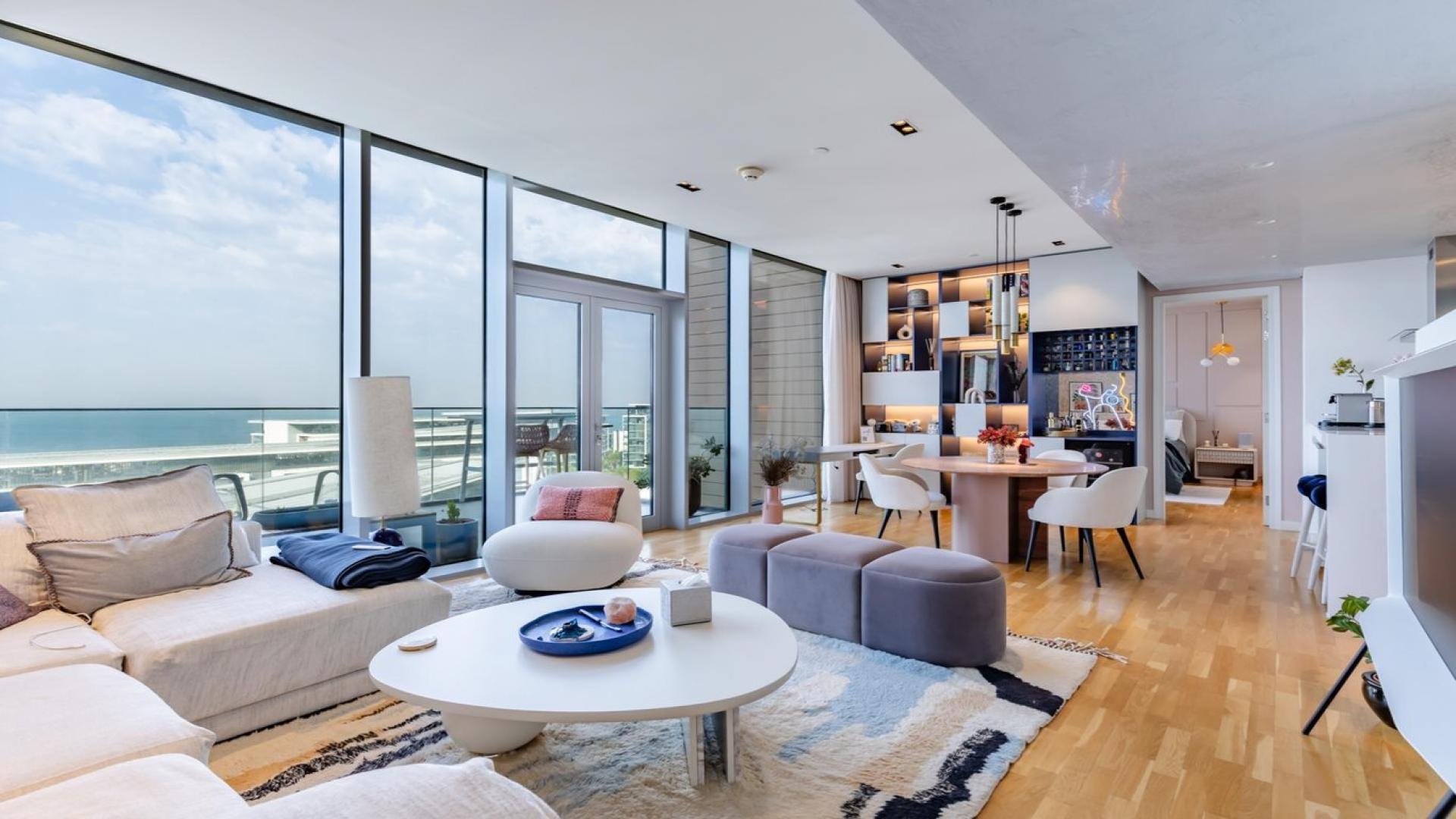 High-floor Bluewaters apartment living room with sea view, modern decor, and large windows