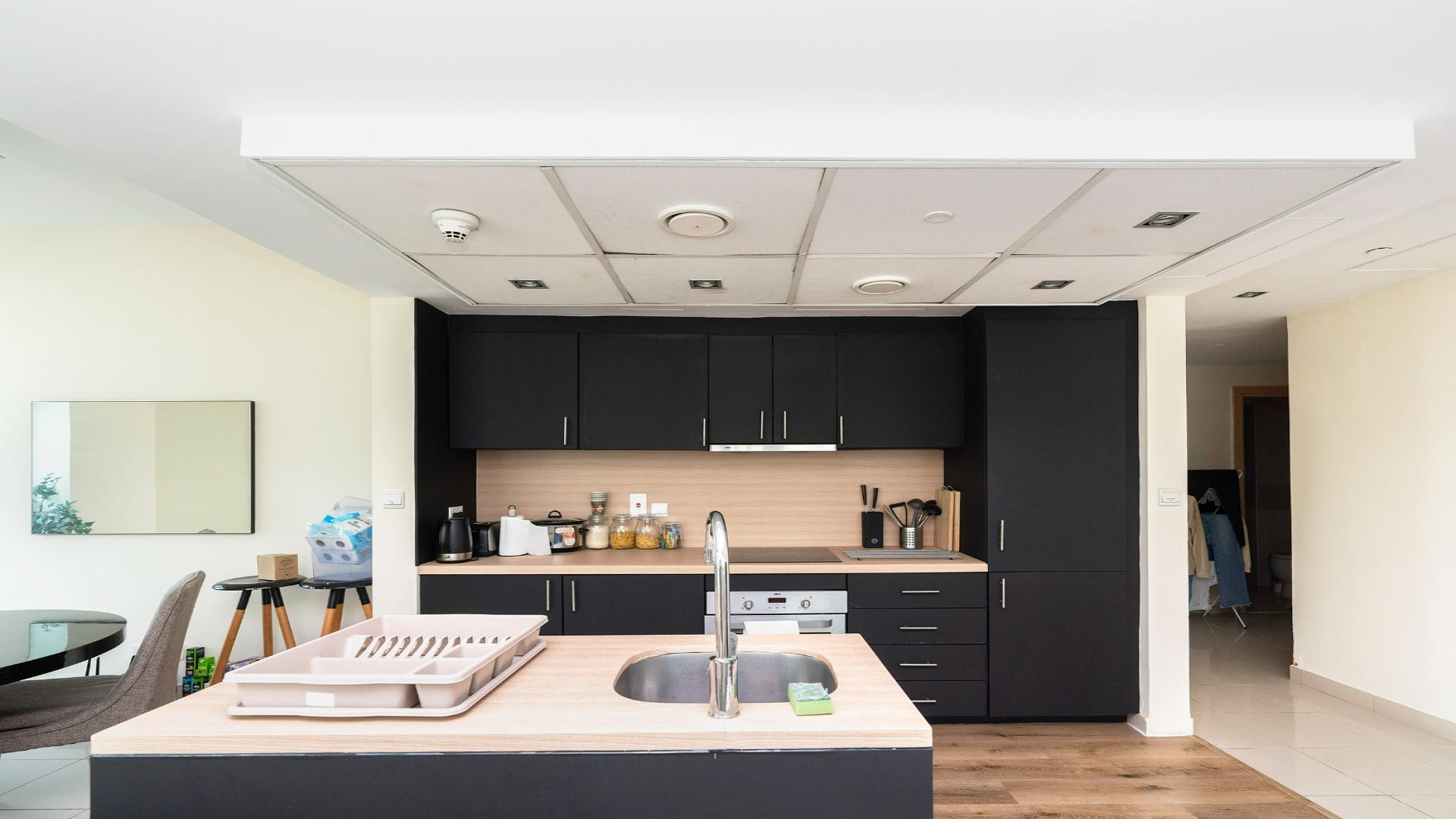 Spacious Dubai Marina apartment living room with modern kitchen and large windows, Park Island