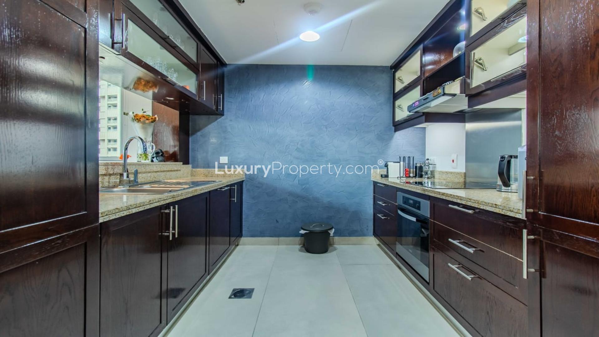 Furnished kitchen in 1-bedroom apartment, The Residences, Downtown Dubai, featuring modern dark wood cabinets