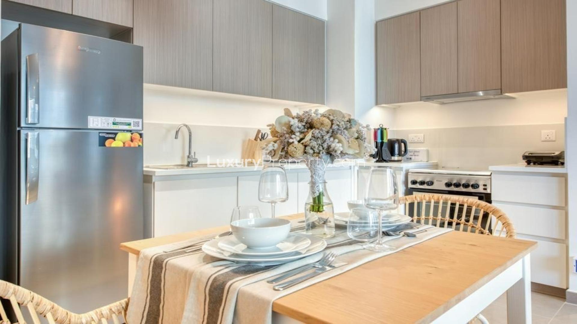 Furnished living room in Dubai Hills Estate apartment with modern decor and natural light