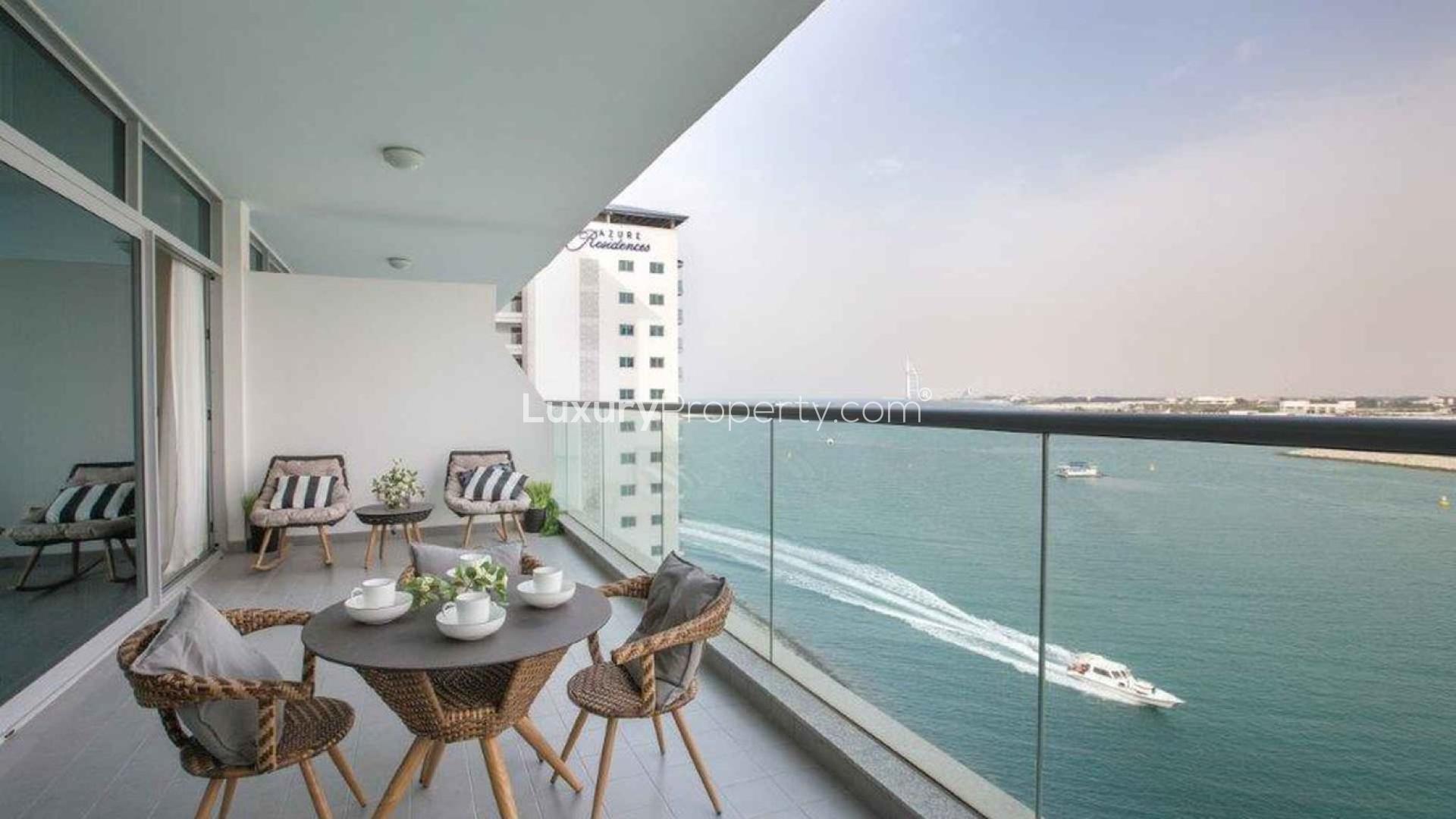"Spacious balcony with sea view at Azure Residences, Palm Jumeirah apartment for sale.",Modern living and dining area in Palm Jumeirah apartment, bright interior with city view