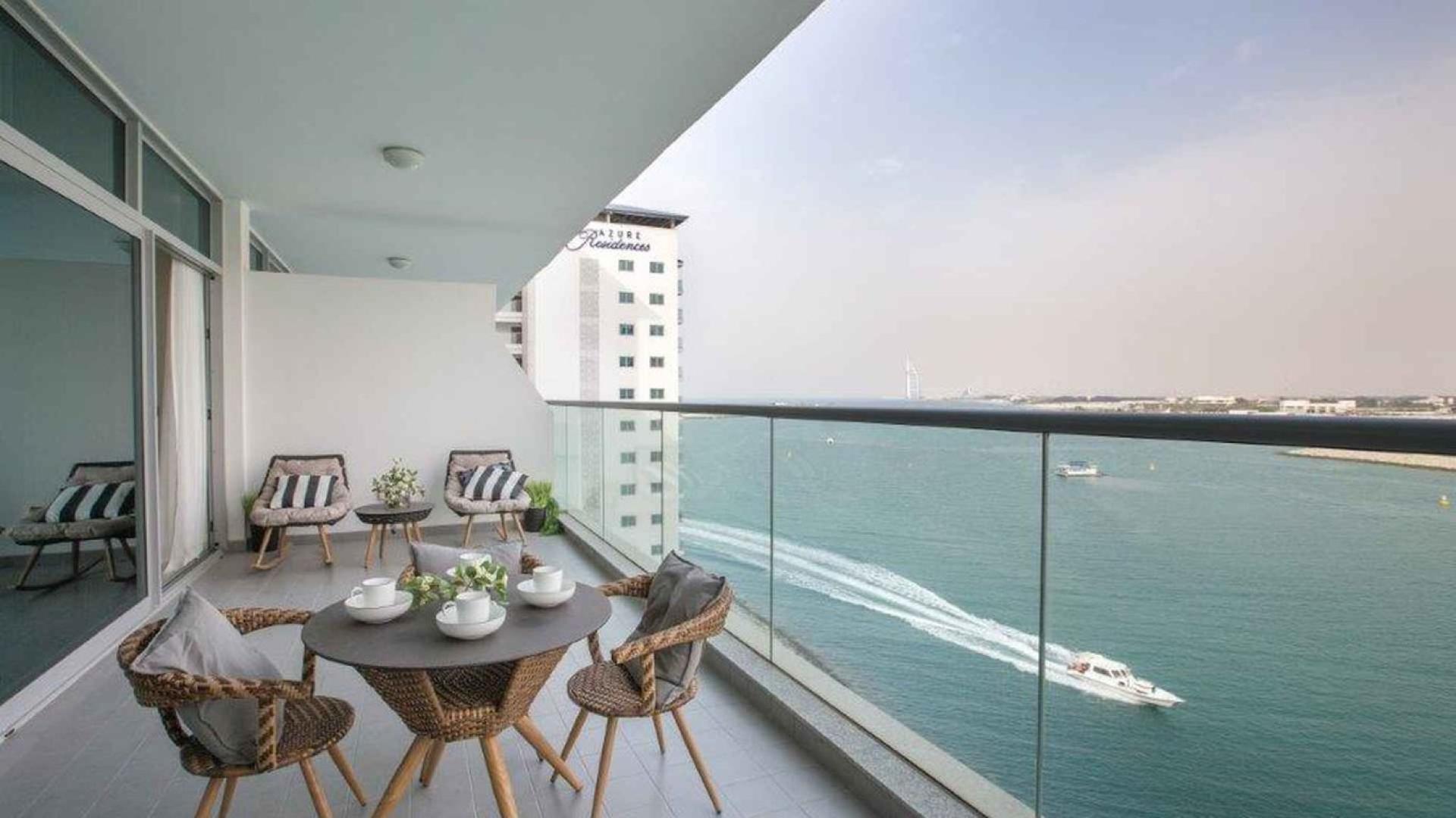 "Spacious balcony with sea view at Azure Residences, Palm Jumeirah apartment for sale.",Modern living and dining area in Palm Jumeirah apartment, bright interior with city view