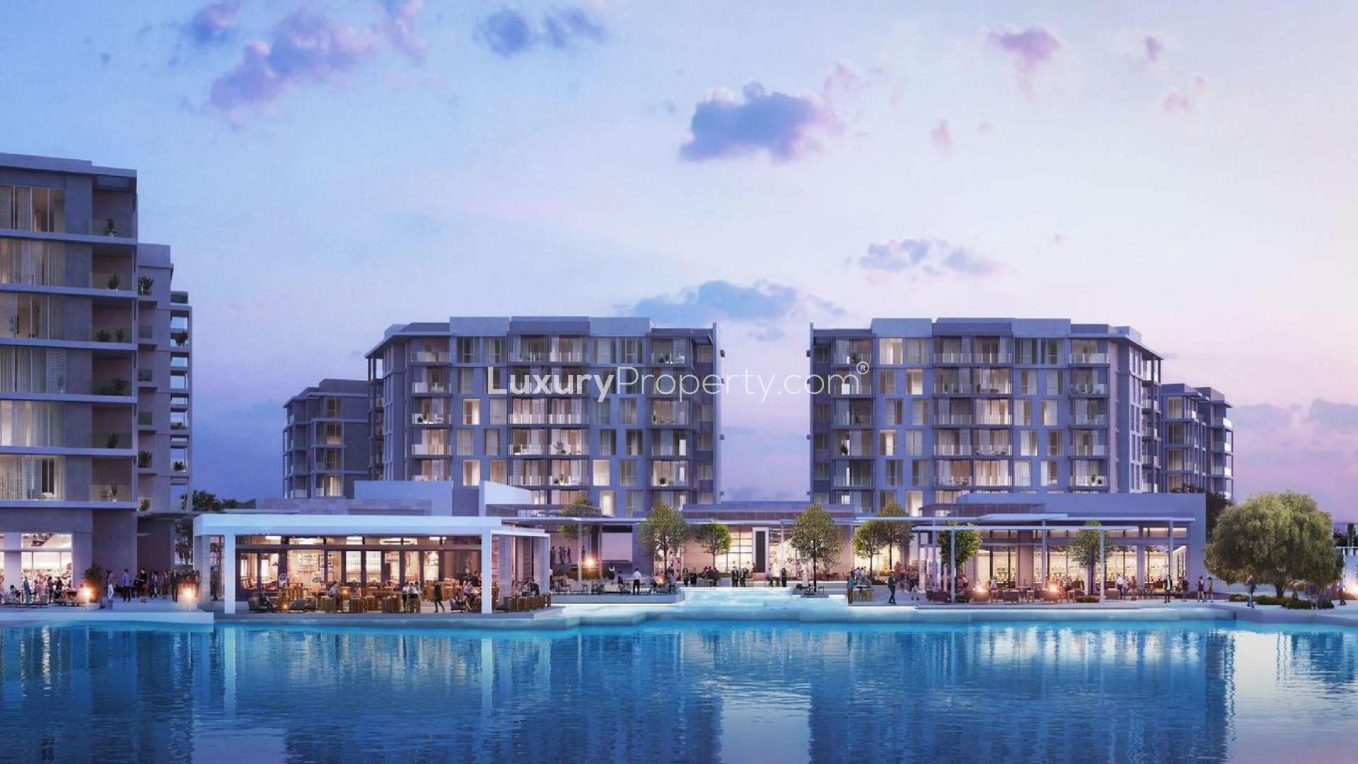 Modern apartment buildings with trees and fountains at Beachside Residences, Tilal Al Ghaf