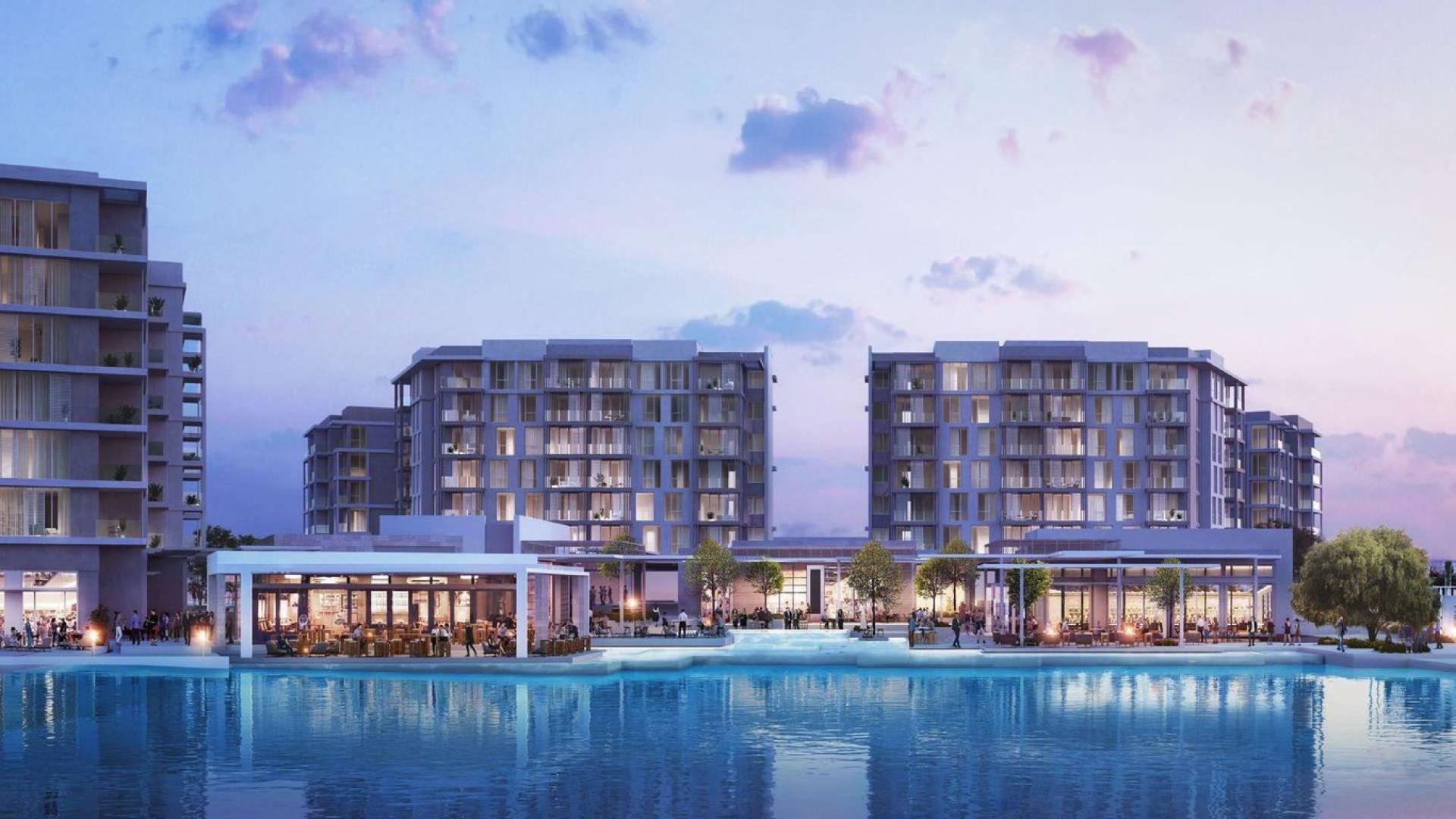 Modern apartment buildings with trees and fountains at Beachside Residences, Tilal Al Ghaf
