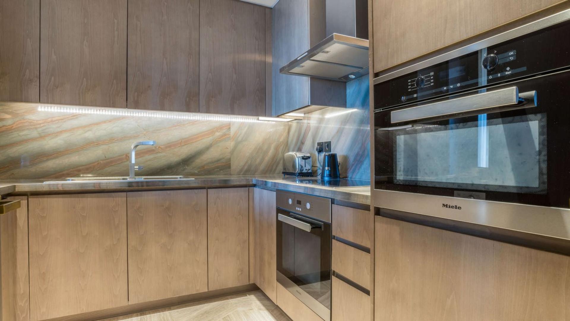 Furnished dining area in serviced apartment at FIVE Palm Jumeirah, with balcony view