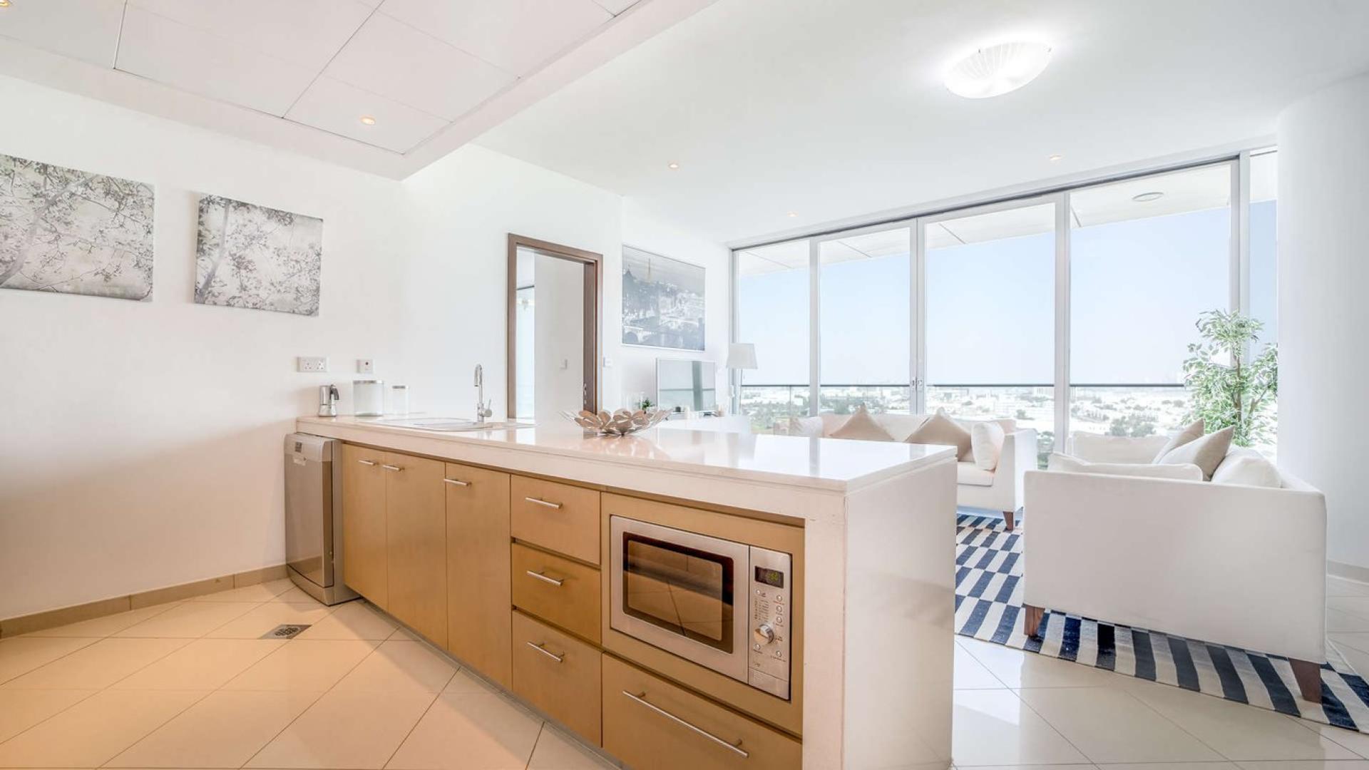 Luxury bedroom with balcony view in Marsa Plaza apartment, Dubai Festival City