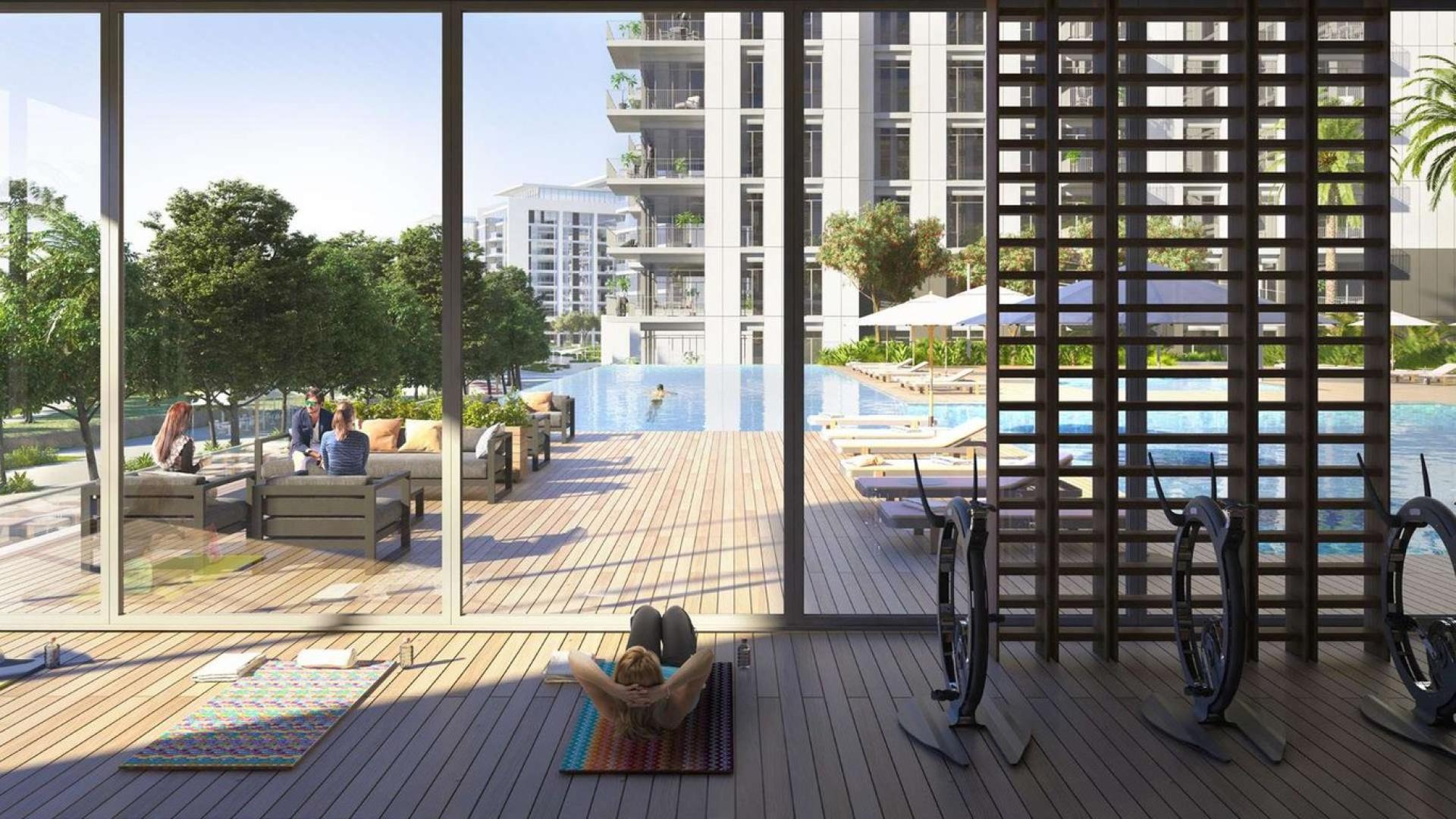 Modern living room and kitchen in Park Ridge one-bedroom apartment, Dubai Hills Estate