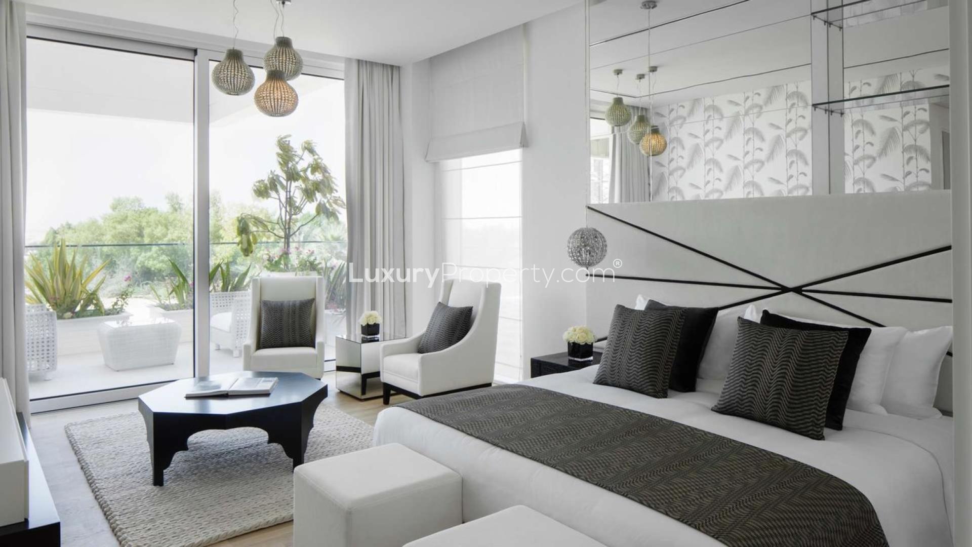 Luxurious living room in one-bedroom apartment, Seventh Heaven, Al Barari. Modern decor and artwork