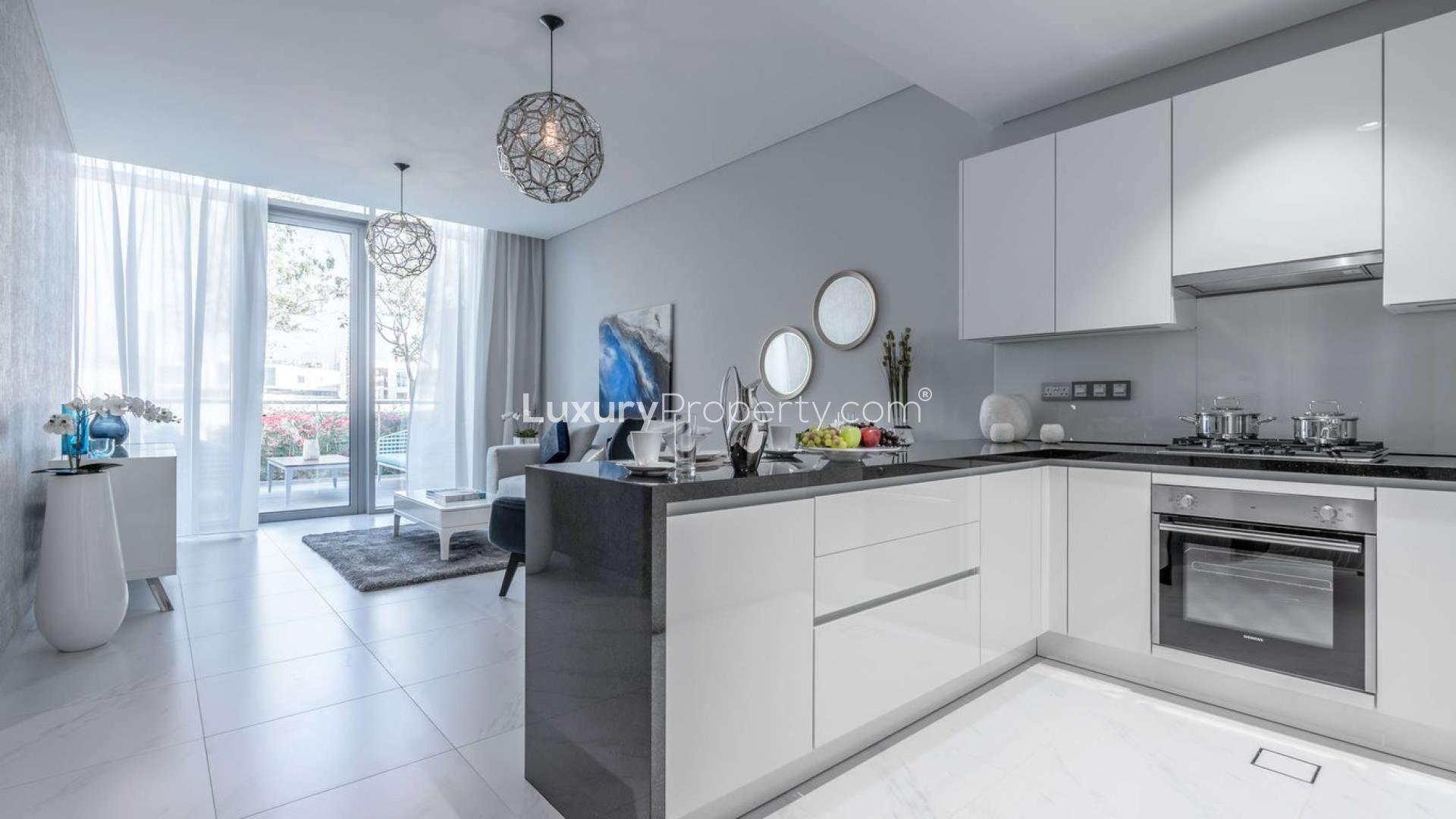 Modern kitchen and living area in Seagull Point apartment, District One, for sale