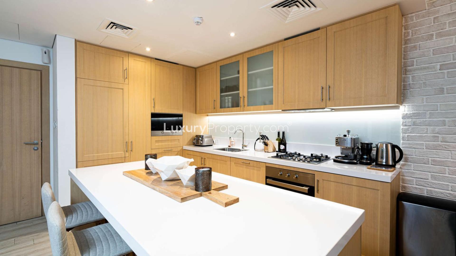 Modern Belgravia 1 apartment exterior with pool view in Jumeirah Village Circle, Dubai