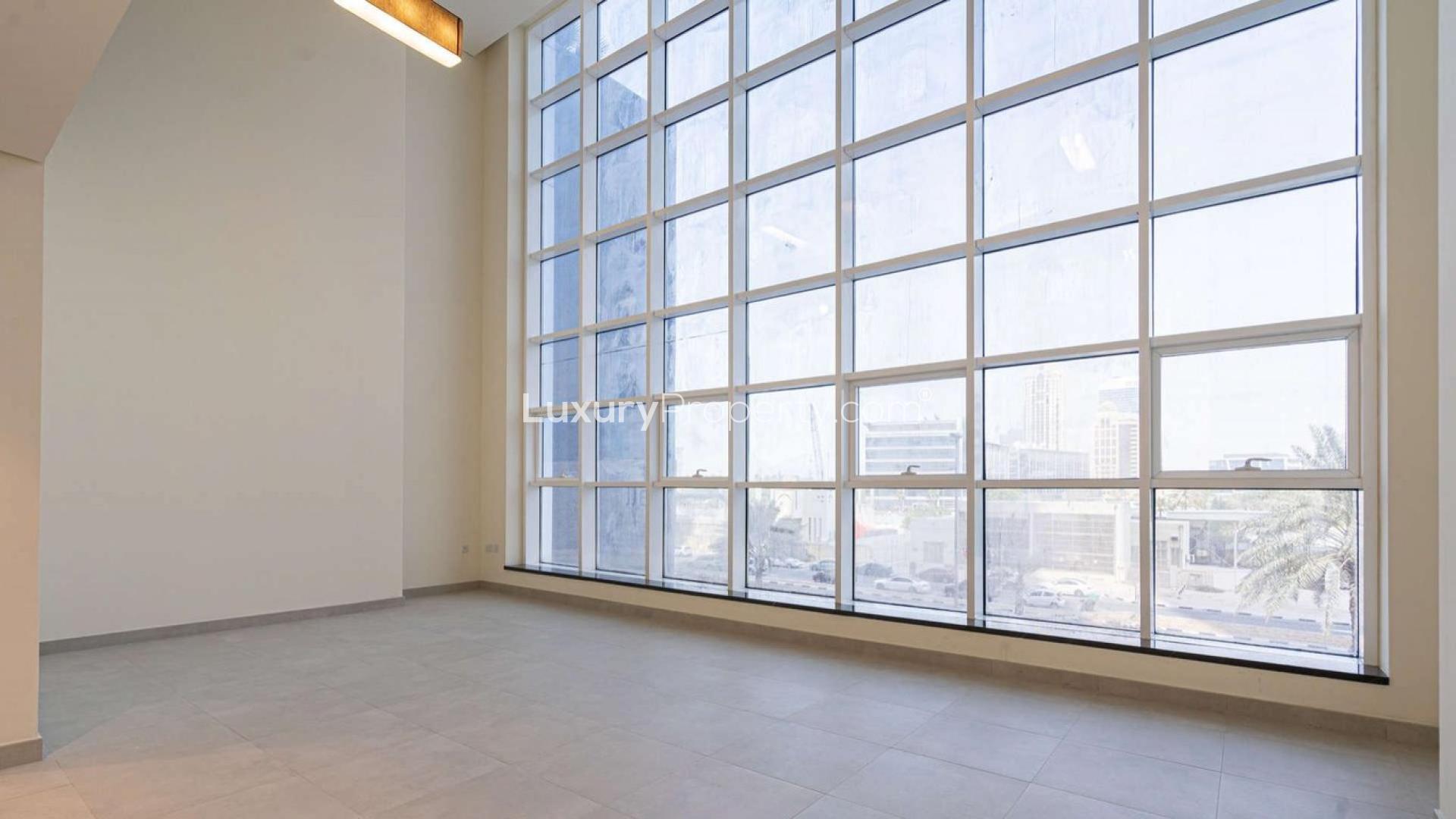 Spacious living area with large windows in Dubai Marina apartment, Marina Arcade Tower