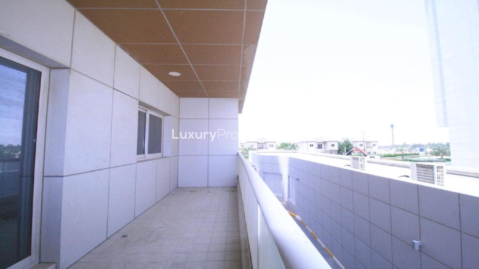 "Spacious balcony with golf views in Living Legends Hercules apartment for sale.",Balcony view from 1-bedroom apartment in Living Legends, Hercules, overlooking golf course