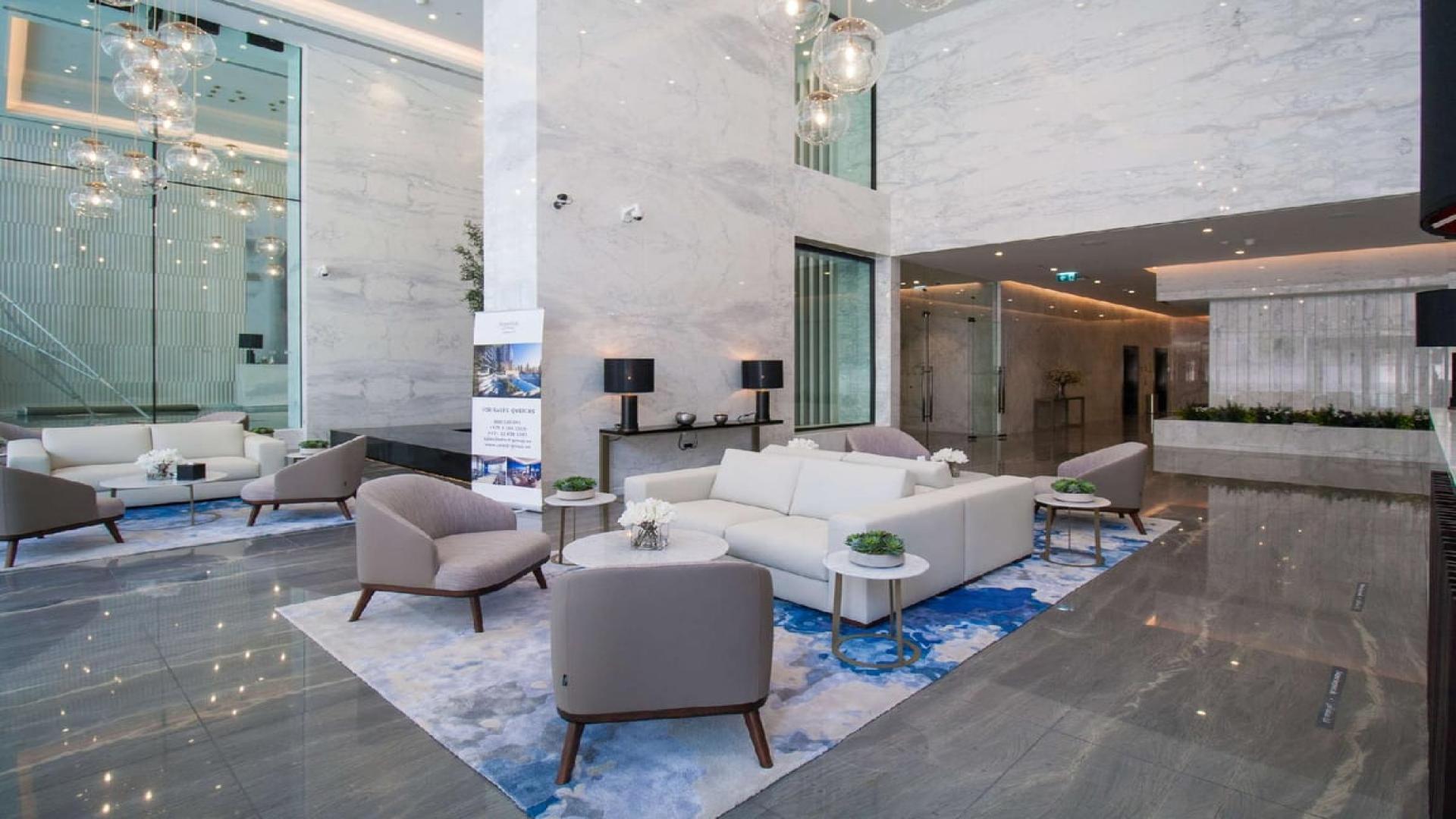Elegant lobby of Marina Gate apartment in Dubai Marina with modern seating and decor