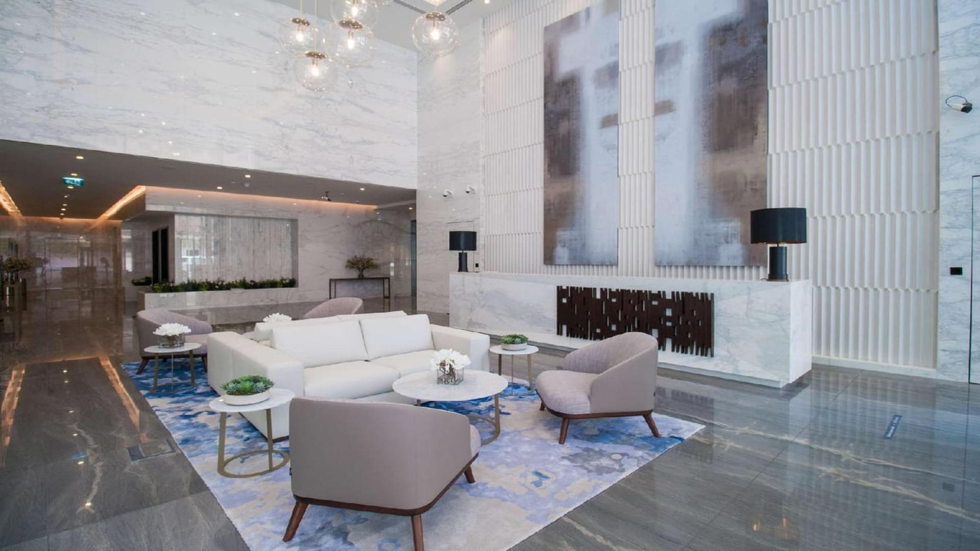 Modern kitchen and living area in one-bedroom apartment at Marina Gate, Dubai Marina