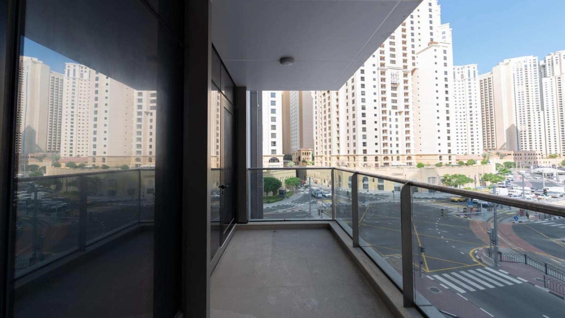 Modern kitchen in Sparkle Towers, Dubai Marina apartment for sale, featuring wooden cabinetry