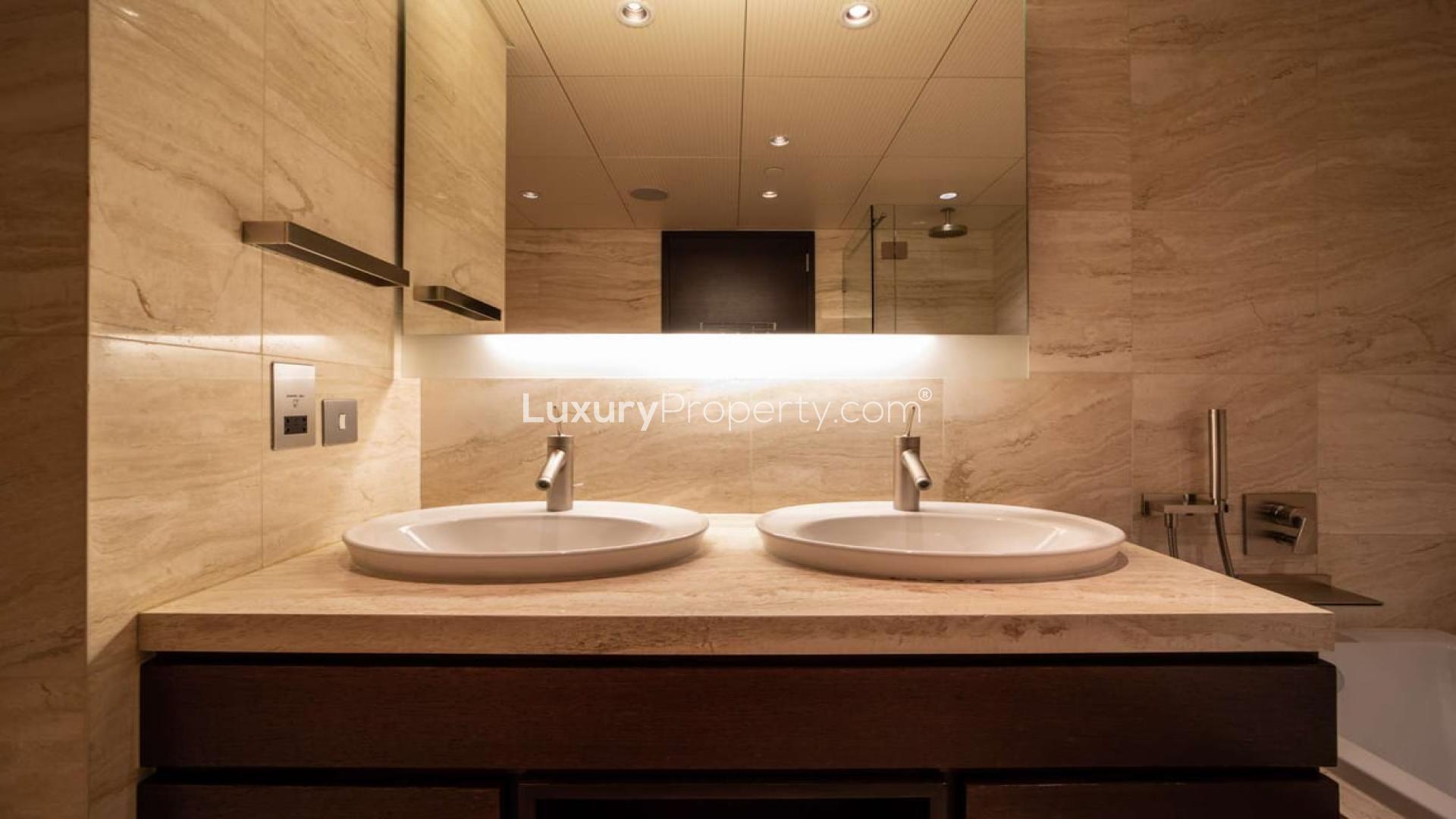 "Modern bathroom with dual sinks in Burj Khalifa apartment, Downtown Dubai, for sale.",Alt text: "View of Burj Khalifa from Downtown Dubai apartment for sale, LP05556.",Luxurious bathroom in one-bedroom Burj Khalifa apartment, Downtown Dubai, featuring modern design elements