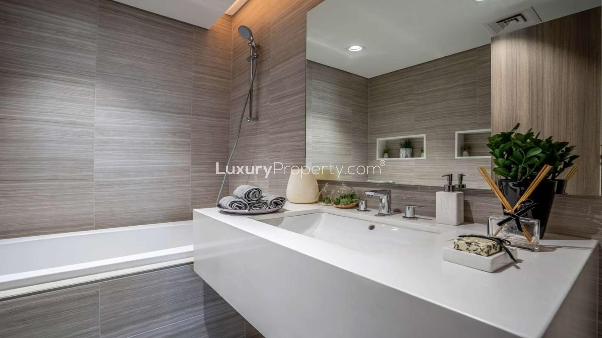 Furnished living room in modern District One apartment, featuring elegant decor and natural light