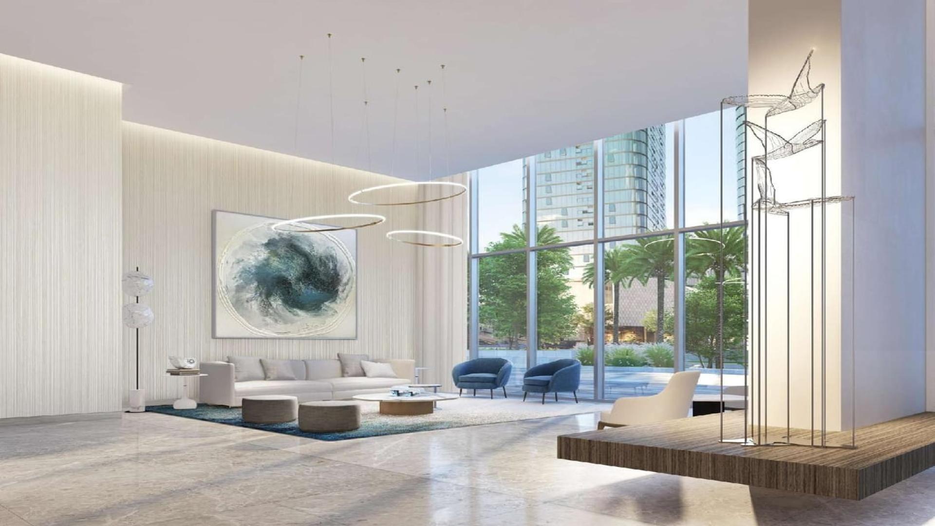 Modern lobby with marble reception in Emaar Beachfront apartment, Dubai Harbour