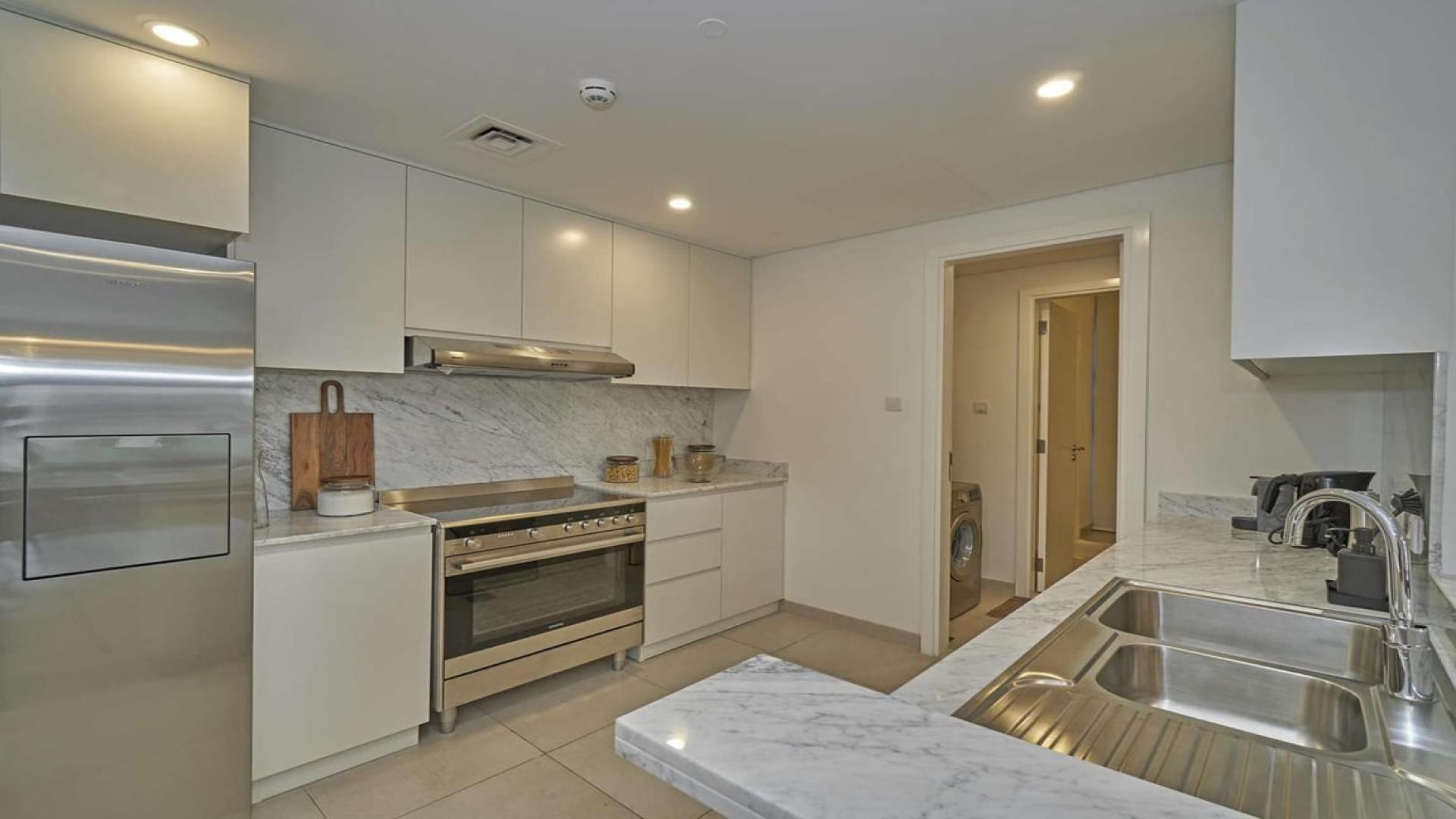 Spacious living and dining area in a three-bedroom apartment for sale near Burj Jumeira