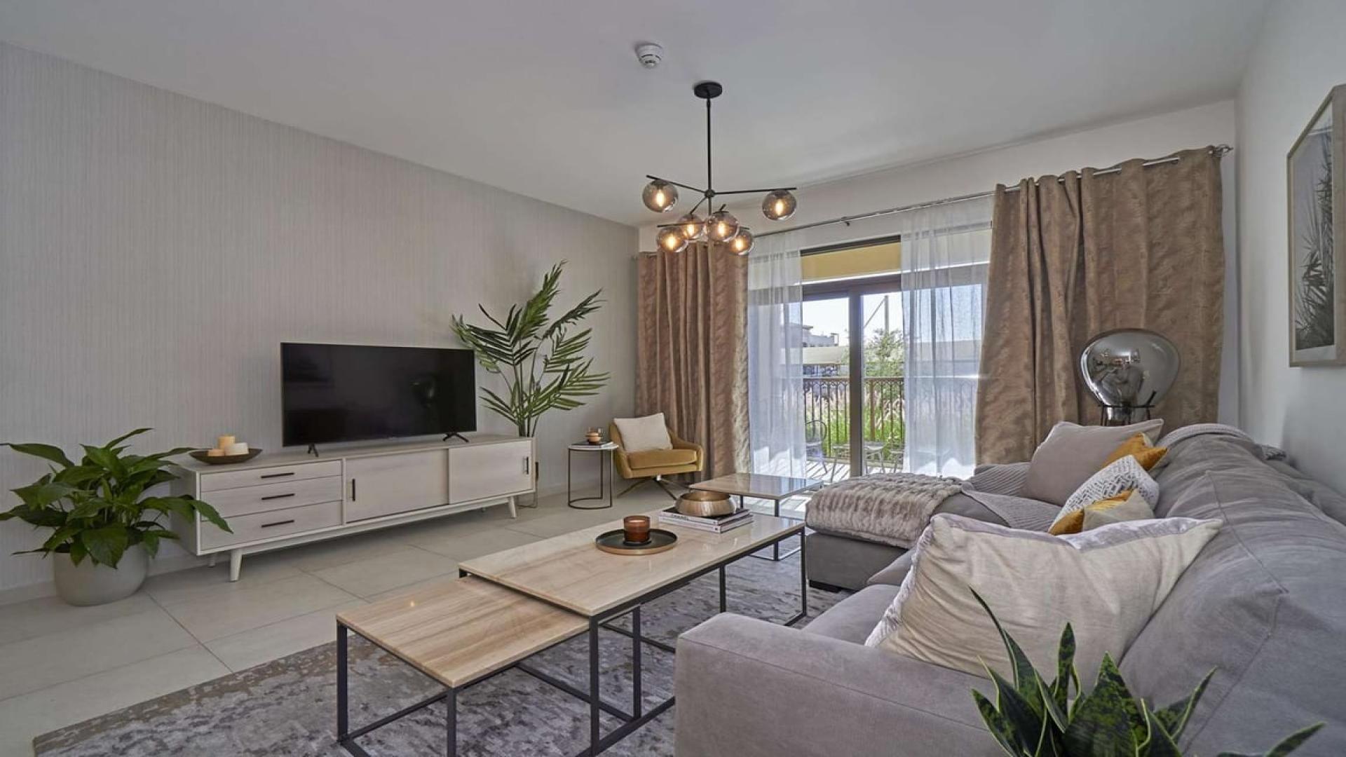 Elegant living room in 4-bedroom Asayel Apartment for sale, featuring modern decor and balcony