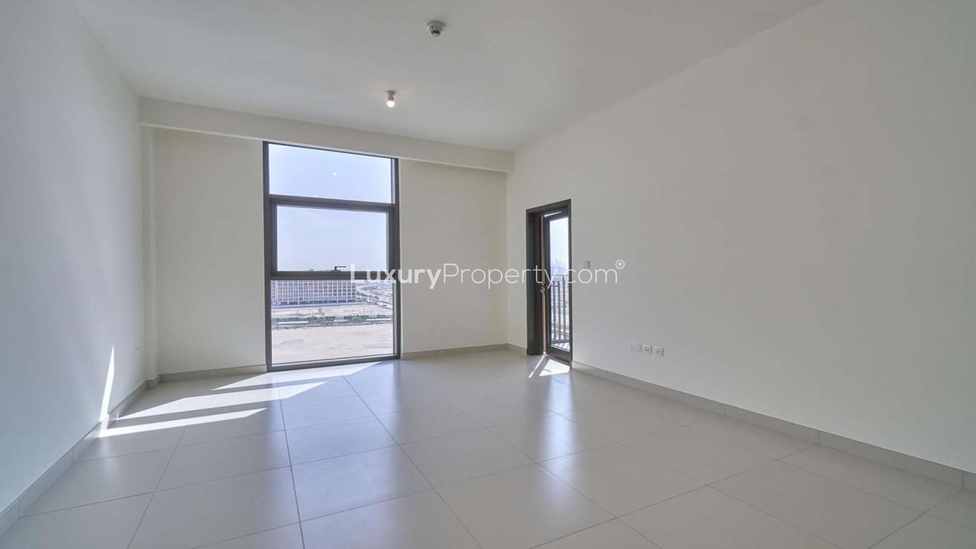 Bright apartment interior with large windows and balcony view in Dubai Hills Estate