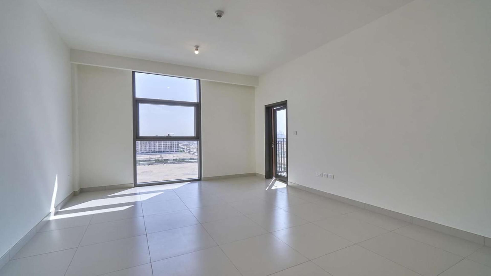 Bright apartment interior with large windows and balcony view in Dubai Hills Estate