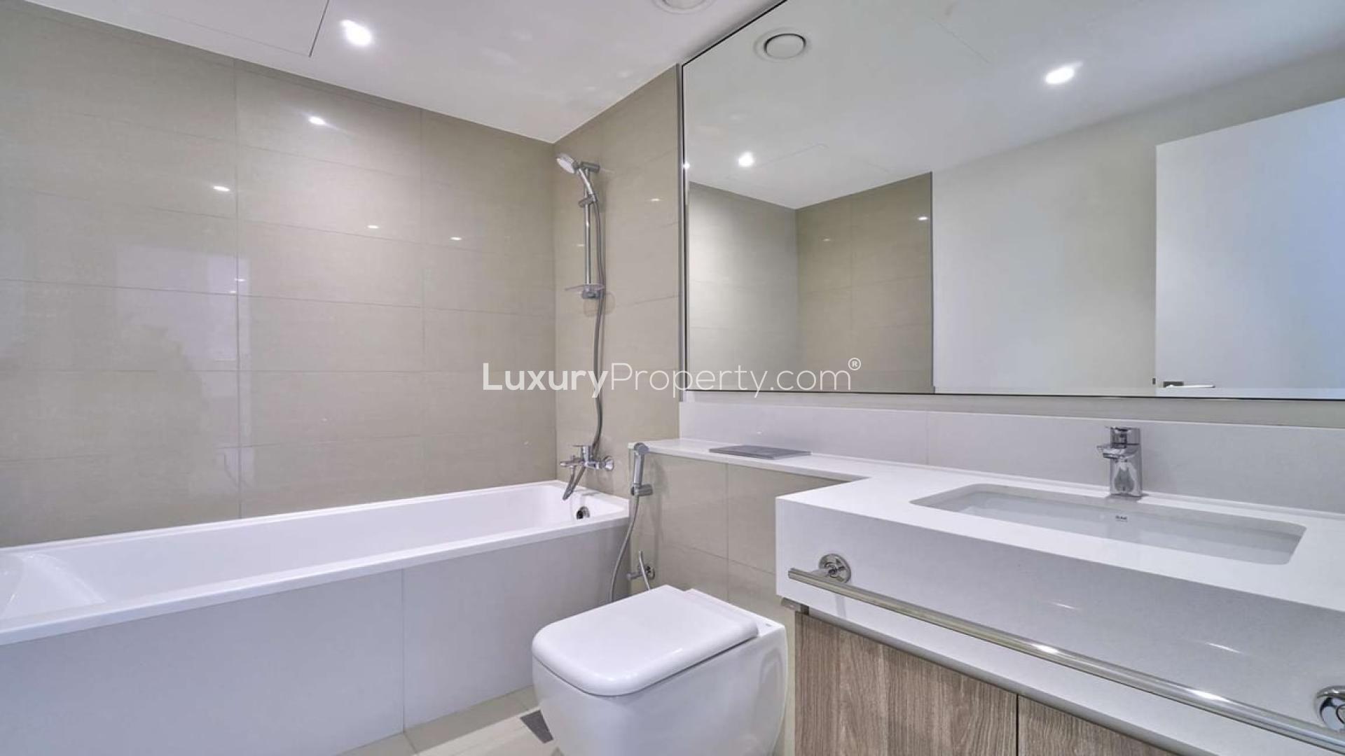 Modern bathroom in one-bedroom Dubai Hills Estate apartment, featuring sleek fixtures and spacious design
