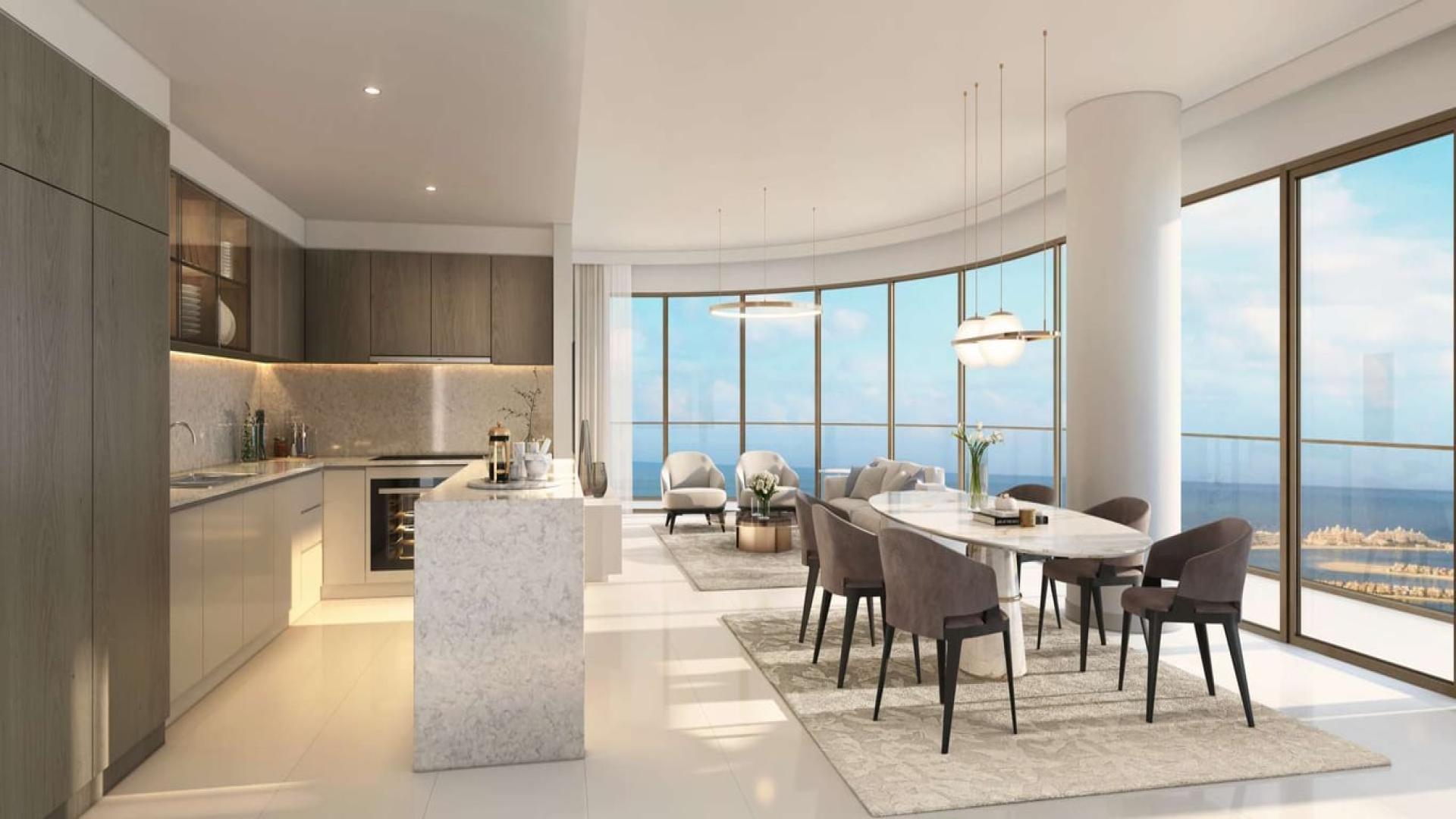 "Luxury apartment balcony with stunning Palm and sea views at Emaar Beachfront, Dubai Harbour.",Modern kitchen and dining area in Dubai Harbour apartment with sea views