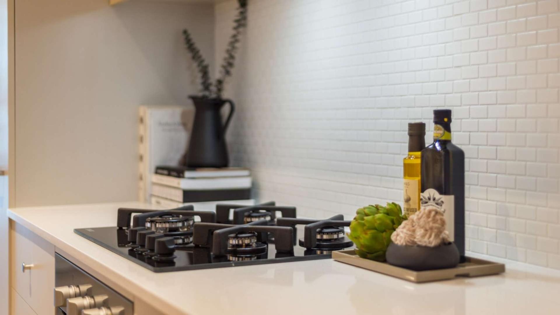 Modern kitchen with sleek gas stove in JVC boutique apartment, The Sloane, for sale