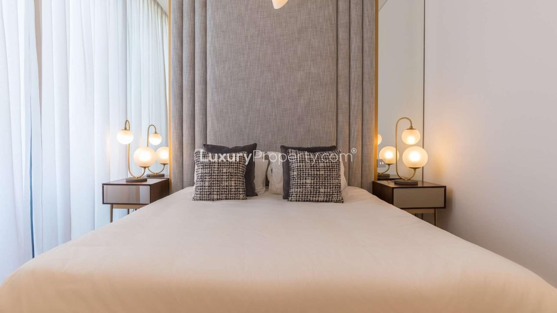 Luxurious Al Barari duplex living room with modern decor and open-plan kitchen