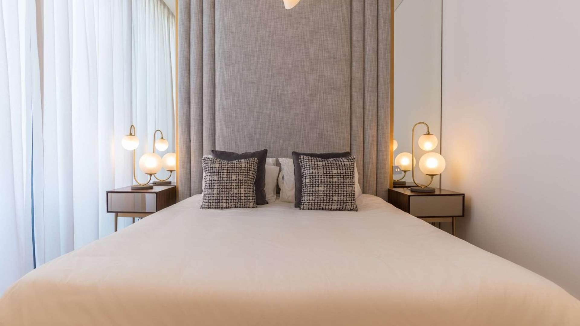 Luxurious Al Barari duplex living room with modern decor and open-plan kitchen