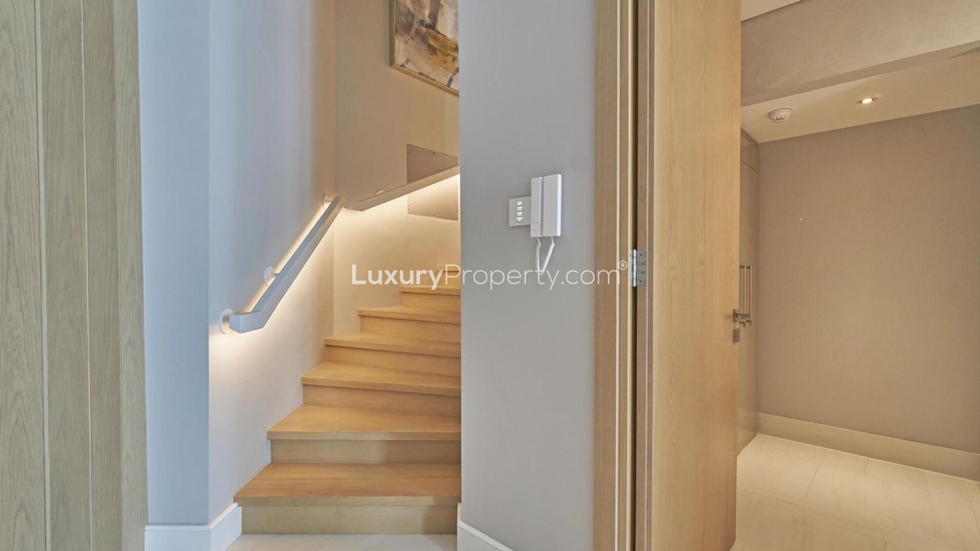 Outdoor pool area with lounge chairs at luxury apartment in SLS Dubai Hotel & Residences