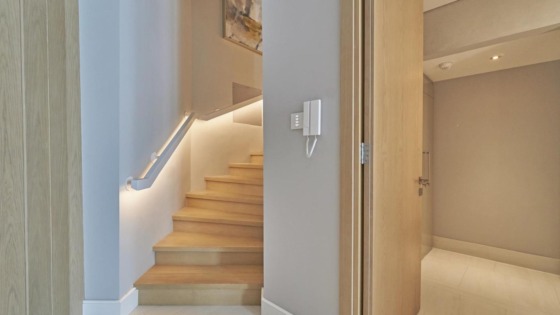 Outdoor pool area with lounge chairs at luxury apartment in SLS Dubai Hotel & Residences