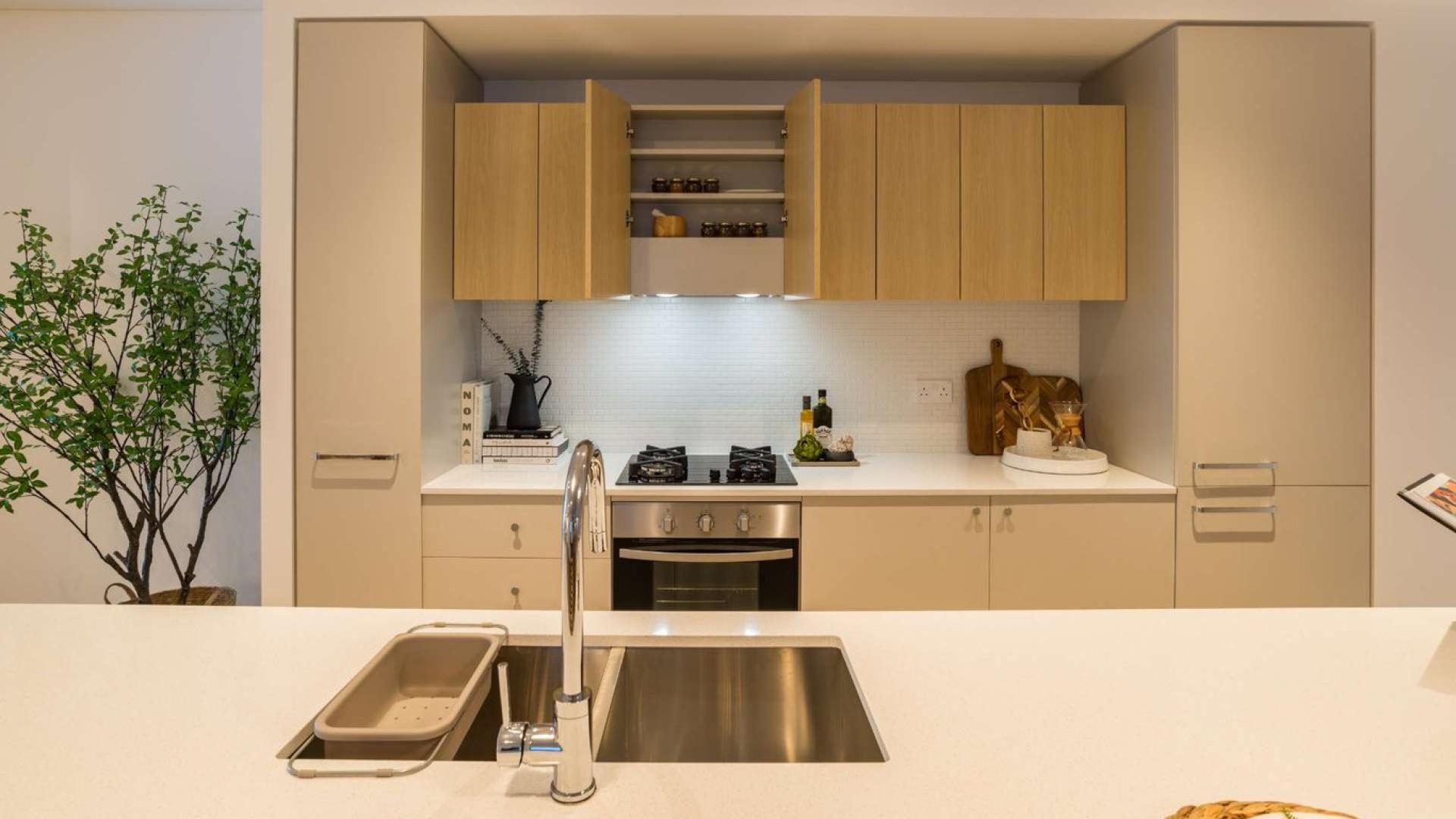 Modern kitchen in luxurious Jumeirah Village Circle studio apartment, The Sloane, for sale