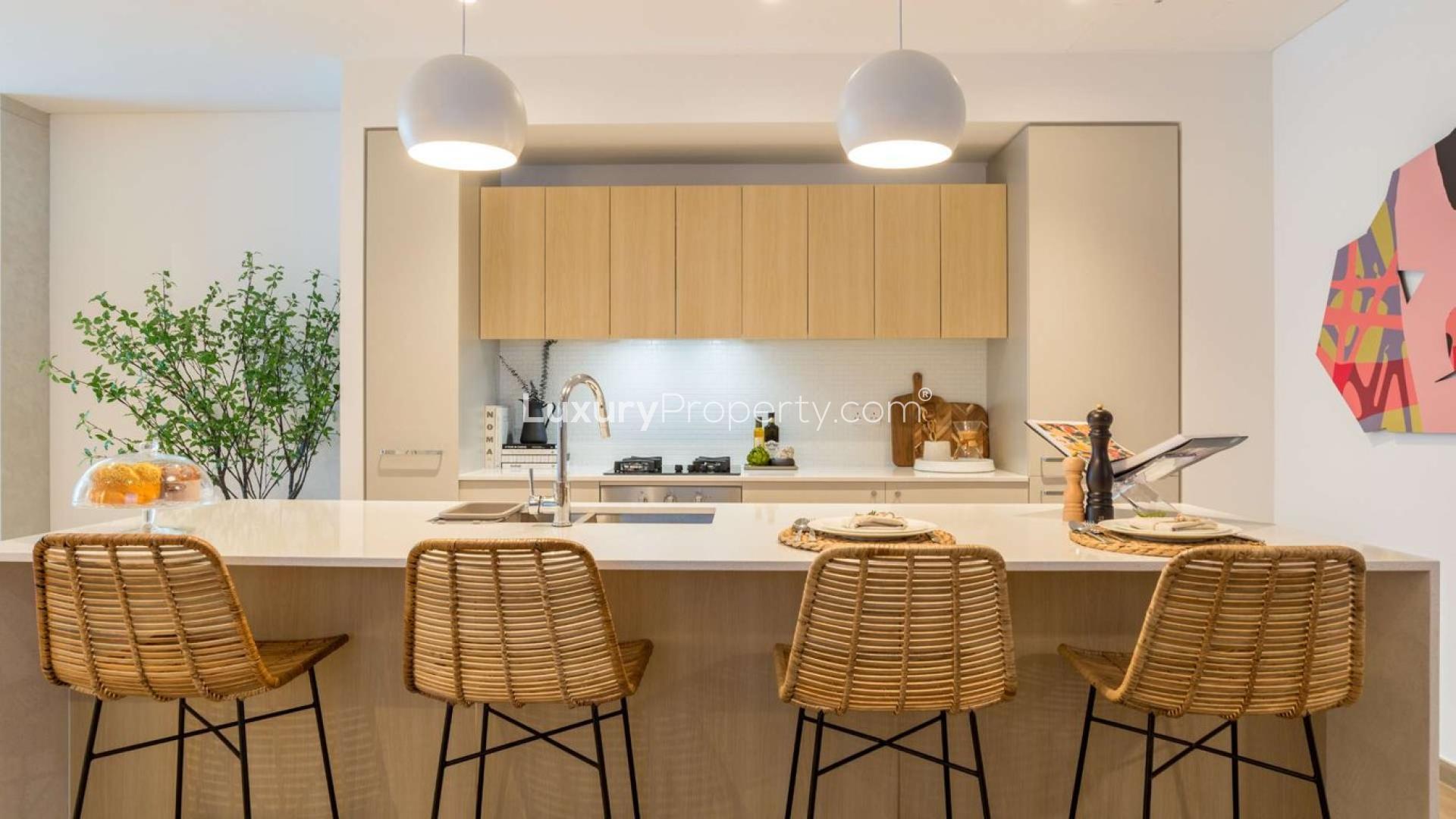 Modern kitchen in Jumeirah Village Circle apartment, featuring sleek shelving and contemporary decor