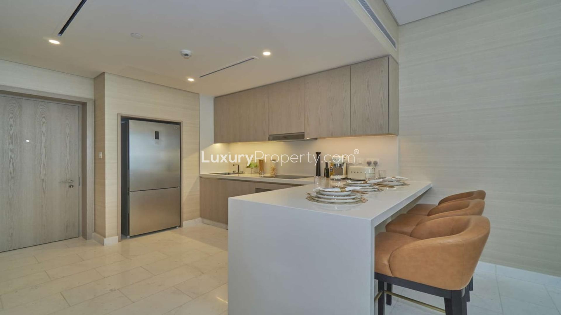 Furnished kitchen in Palm Jumeirah apartment, modern design, with island and seating area