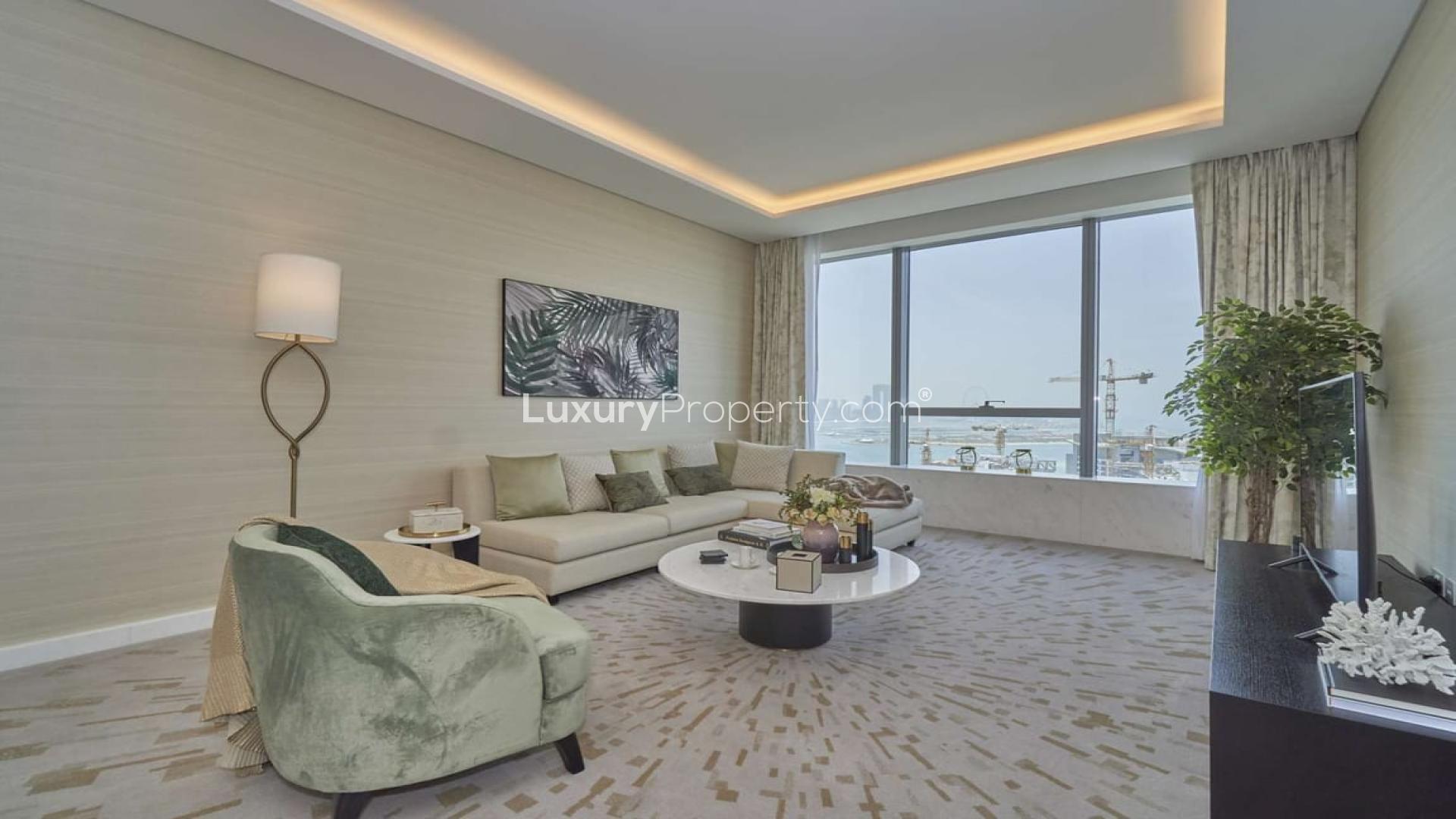 Furnished living room in Palm Jumeirah apartment, stylish decor, large window view
